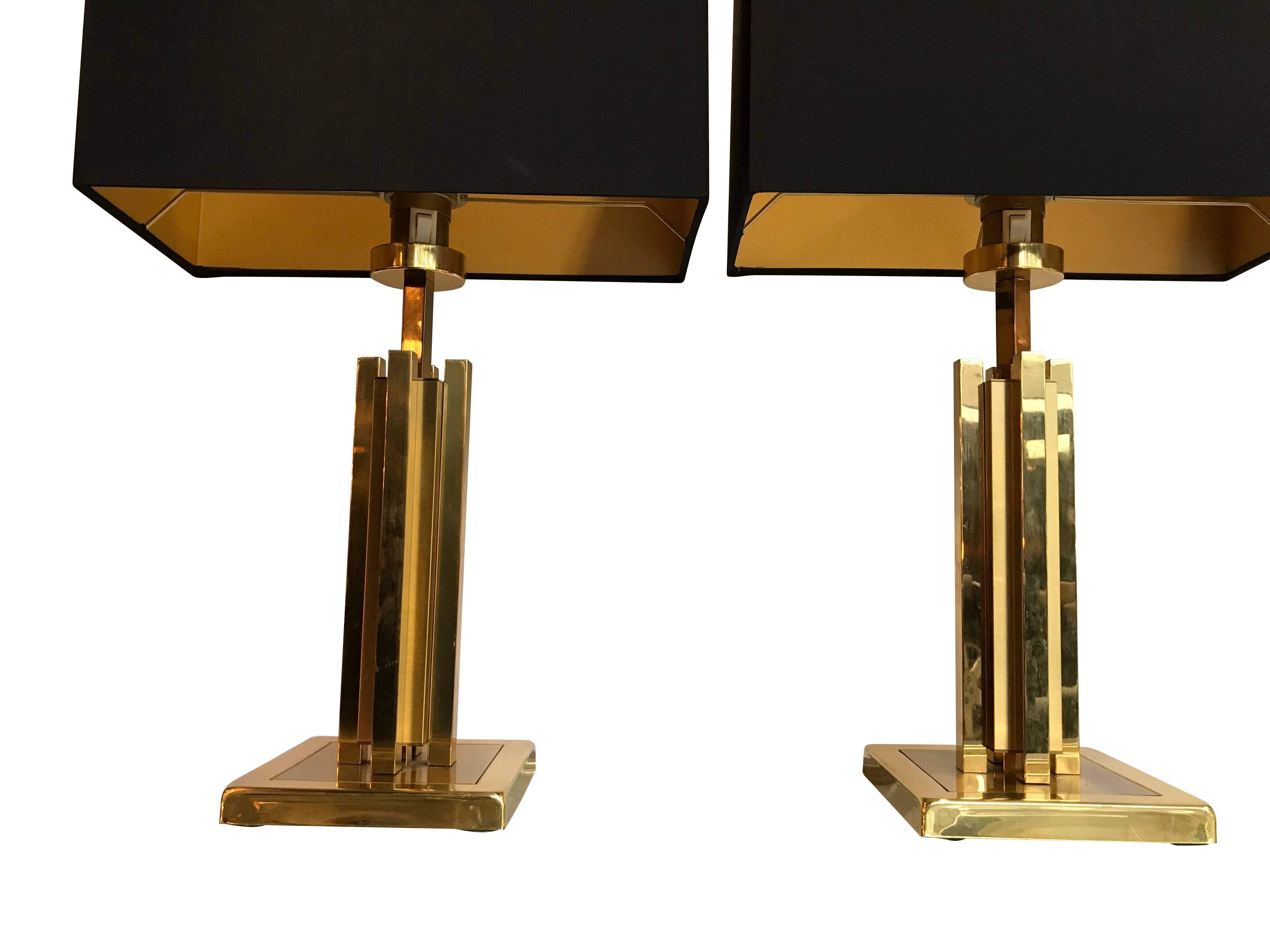 A pair of Willy Rizzo brass table lamps with a combination of polished and mat brass finish, with new bespoke black silk shades with gold interiors. Re wired with antique gold cord flex and PAT tested.