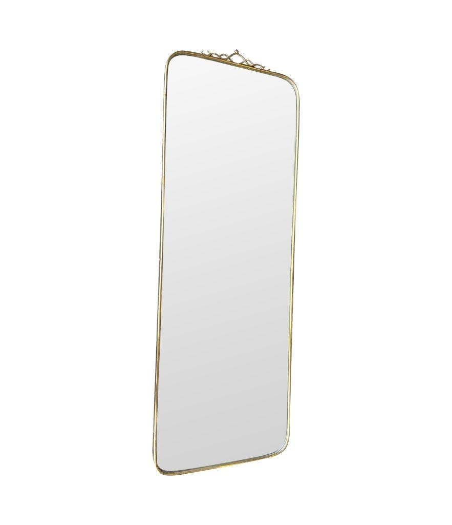 An orignal Italian 1950s brass framed mirror with scroll top detail For Sale 8