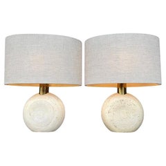 A pair of circular Italian 1970s travertine and brass lamps by Fratelli Manelli