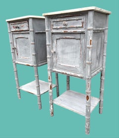 A pair of French 1930s faux bamboo painted wood and marble bedside tables