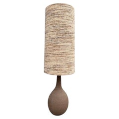 A large French 1960S biscuit fired pottery floor lamps with orignal shade.
