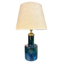 A lovely Italian 1970s green ceramic and brass lamp with orignal rattan shade