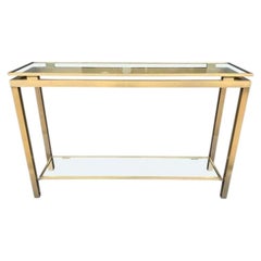 A 1970s Guy Lefevre style gilt metal console table with two glass shelves