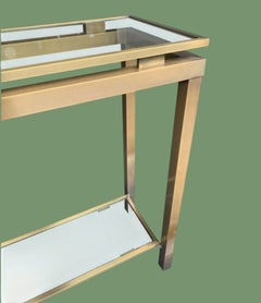 A 1970s Guy Lefevre style gilt metal console table with two glass shelves