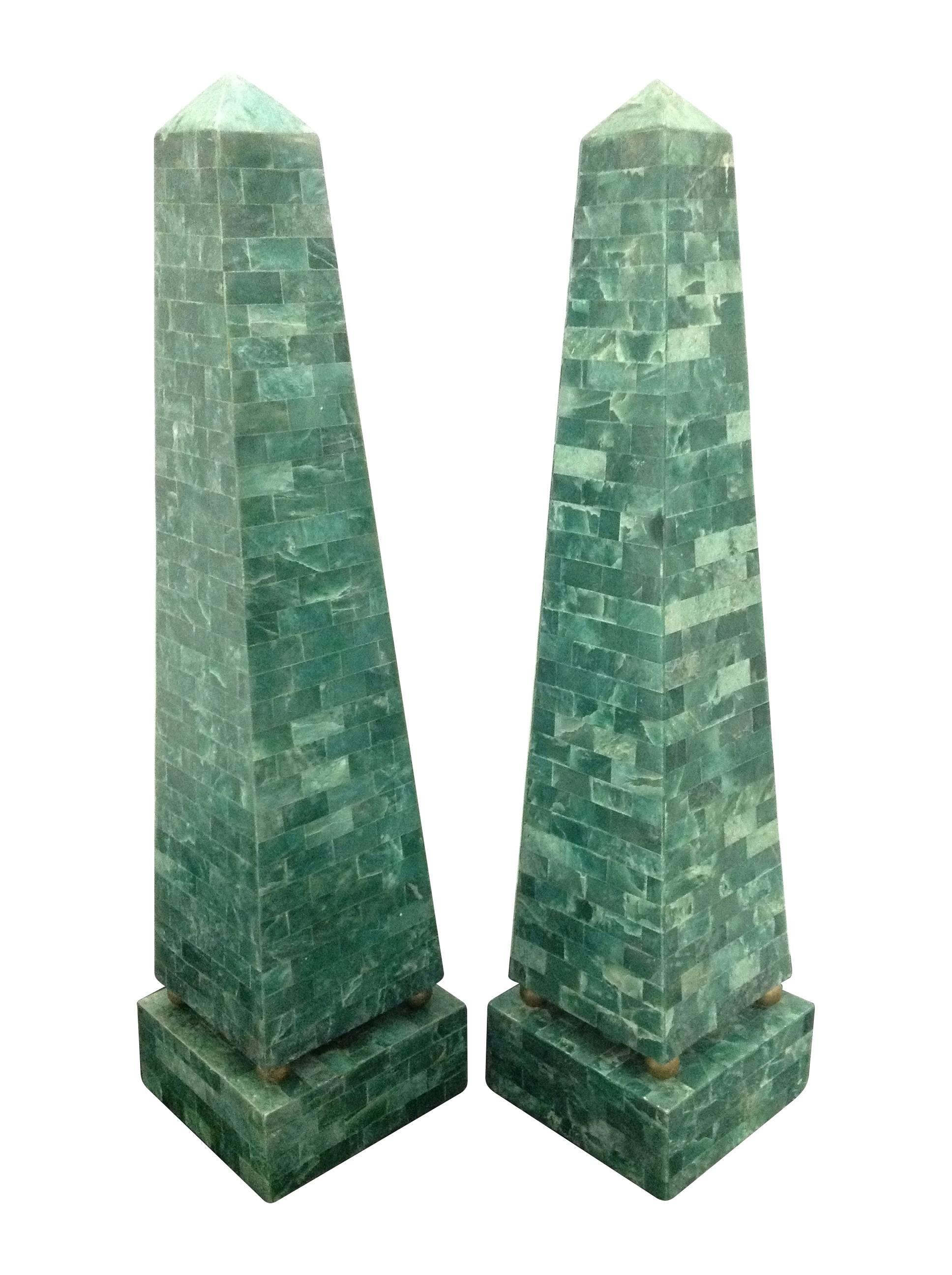 A pair of Maitland-Smith green shell obelisks, each mounted on four brass balls on green shell plinth. With Maitland Smith original sticker on the felt base.