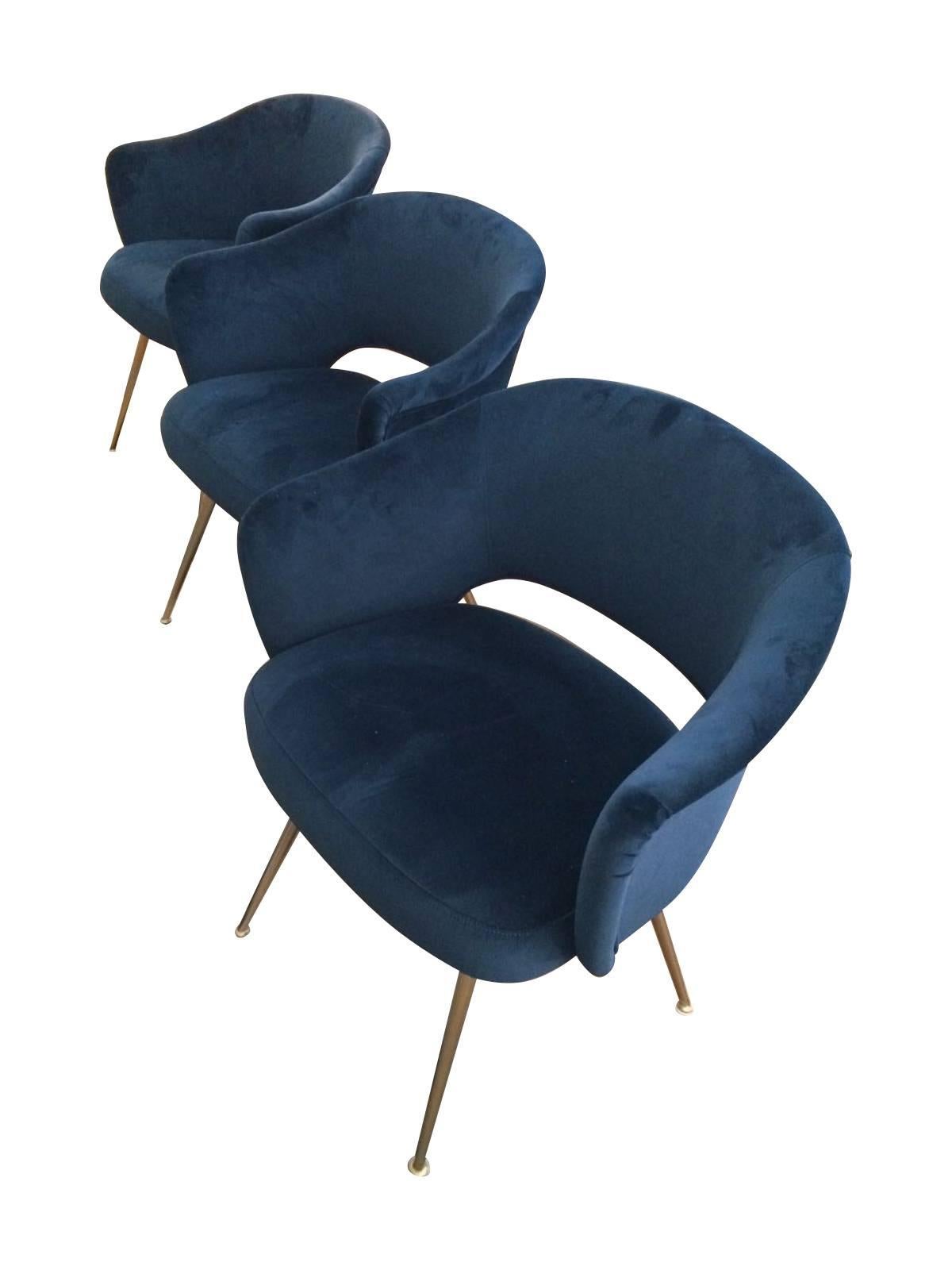 A set of four Italian chairs with arms, with gilt metal legs reupholstered in blue velvet. These chairs can be used as office or dining chairs and are extremely comfortable.