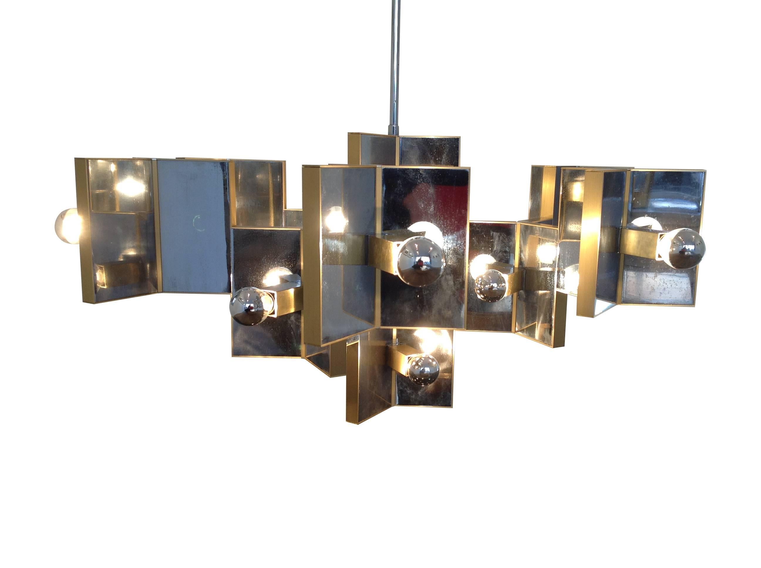 A large Gaetano Sciolari twenty-one-light chandelier, with brass and polished chrome plates, suspended from a chrome rod. In lovely condition for its age, with original Sciolari sticker in the ceiling mount. Re wired and PAT tested.