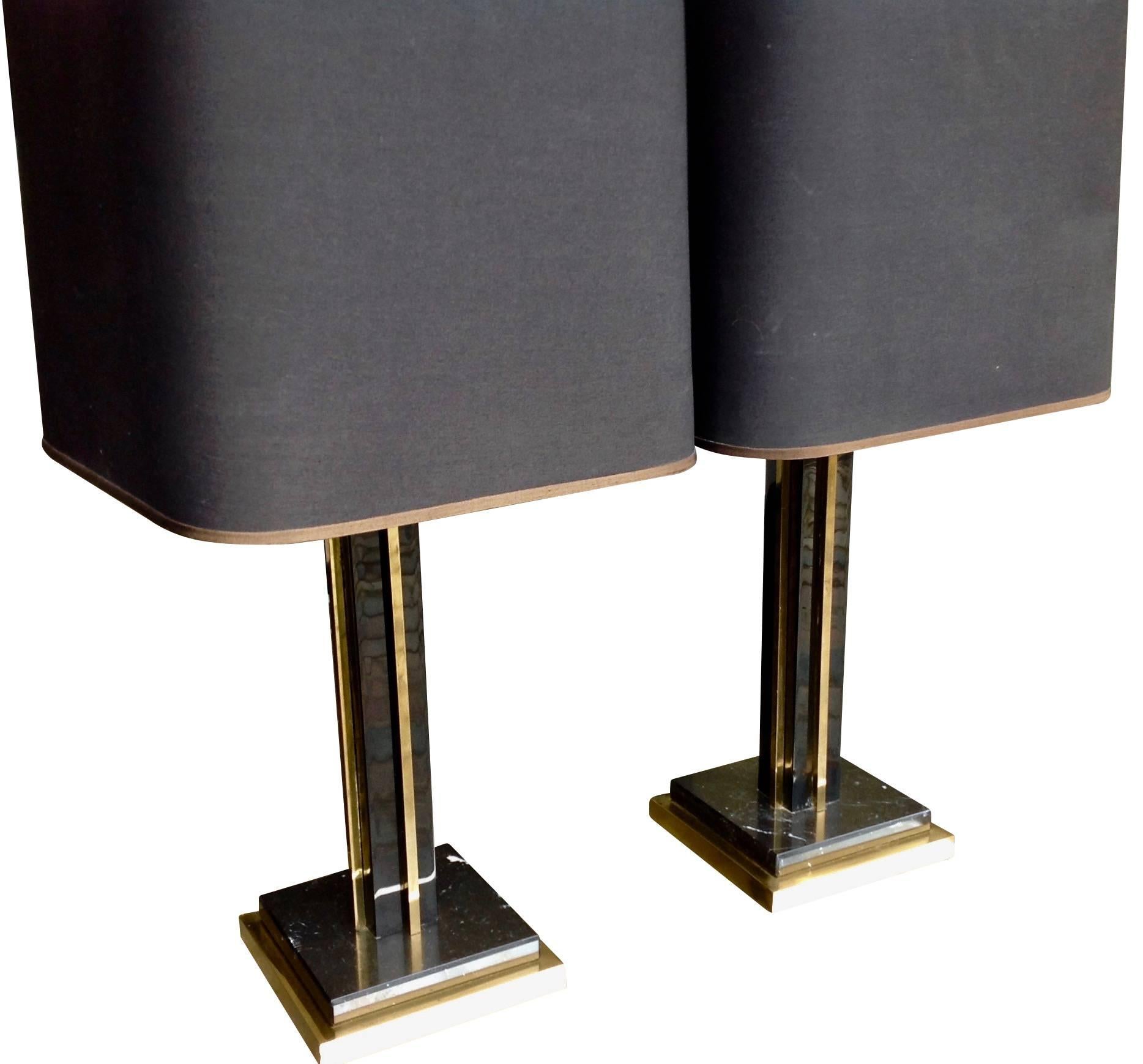 A lovely pair of Willy Rizzo lamps with black metal and brass stems on brass and marble bases. With original black shades with gold interiors, re wired with black cord flex and switch and PAT tested.