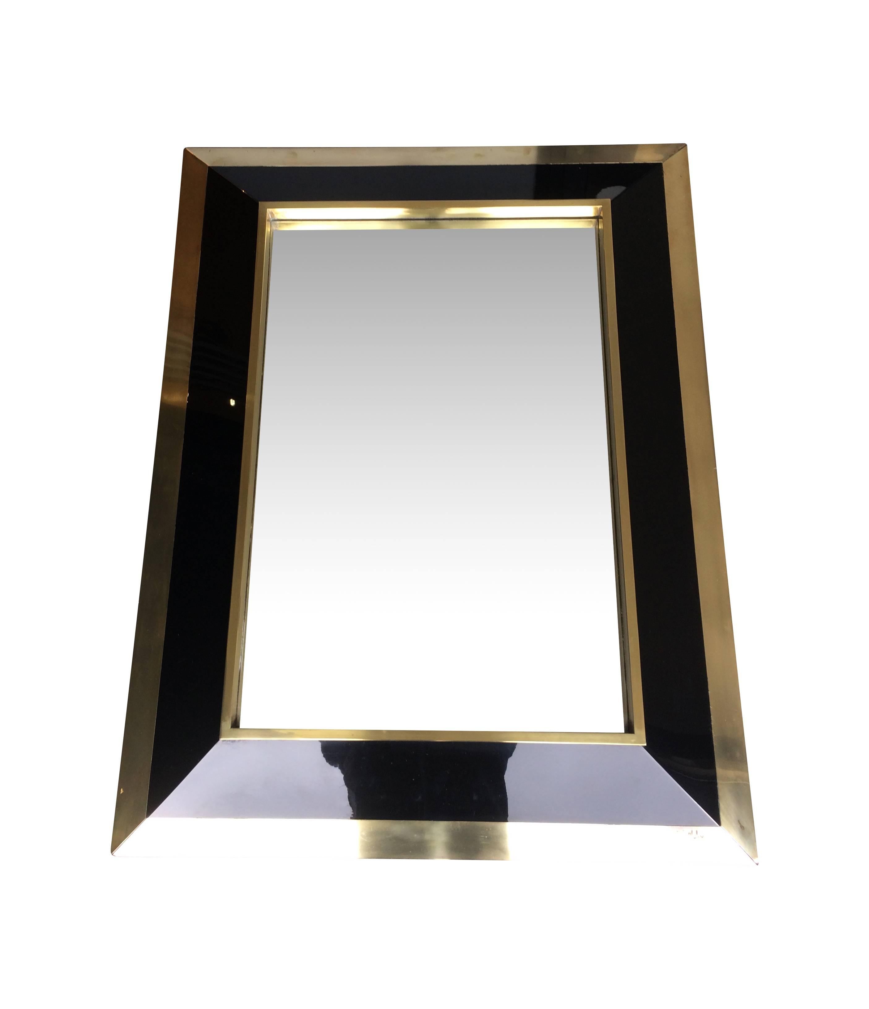 A Jean Claude Mahey brass and black lacquer mirror with angled convex front. Signed on the front bottom right hand corner. J C Mahey 
Matches other listing for brass and black lacquer console, please ask for price for both.