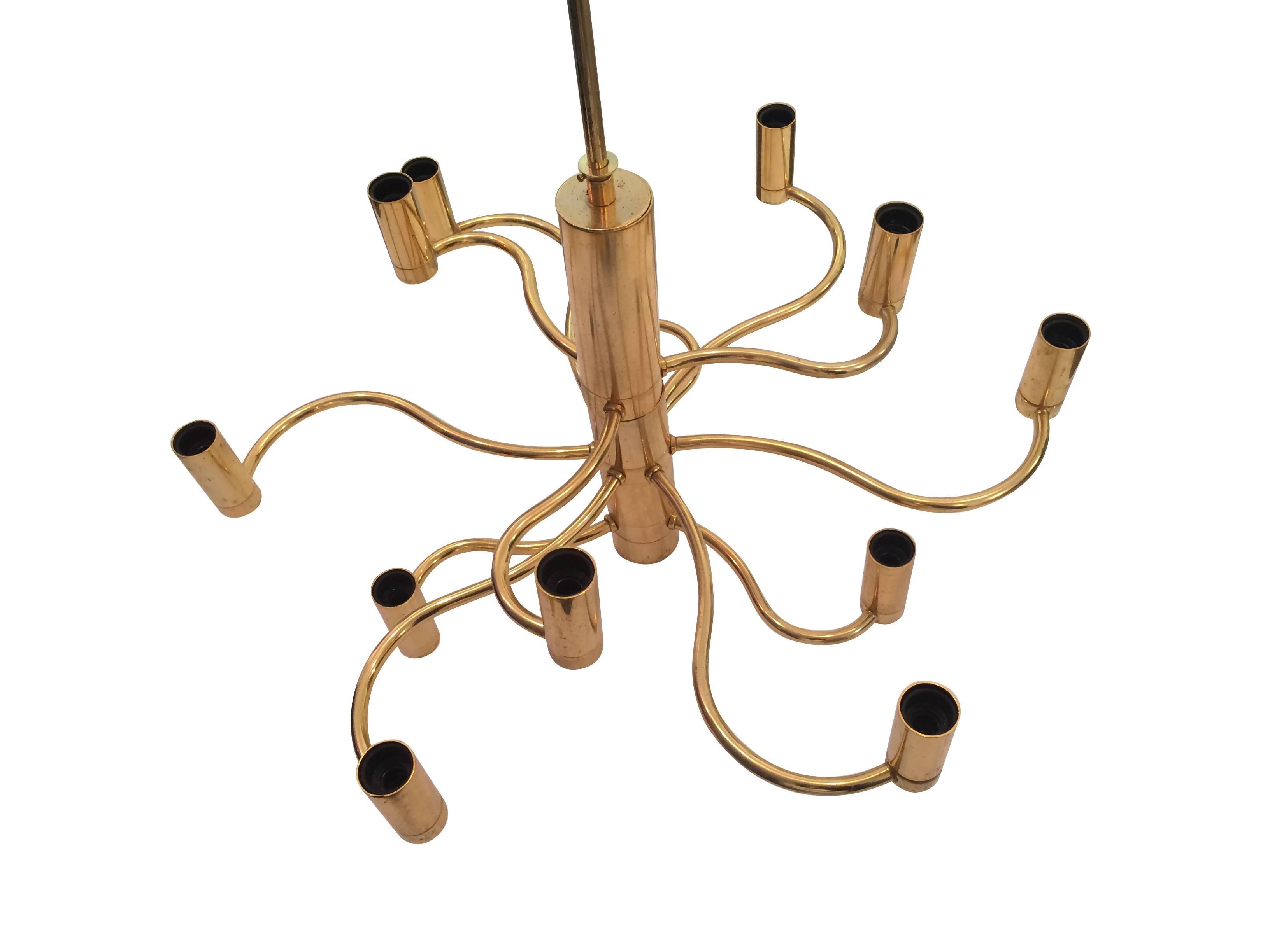 A Gaetano Sciolari brass chandelier, with 12 curved arms and lights, re wired with new bulb fittings and PAT tested. The height of the drop can be altered either shorter or longer as required.