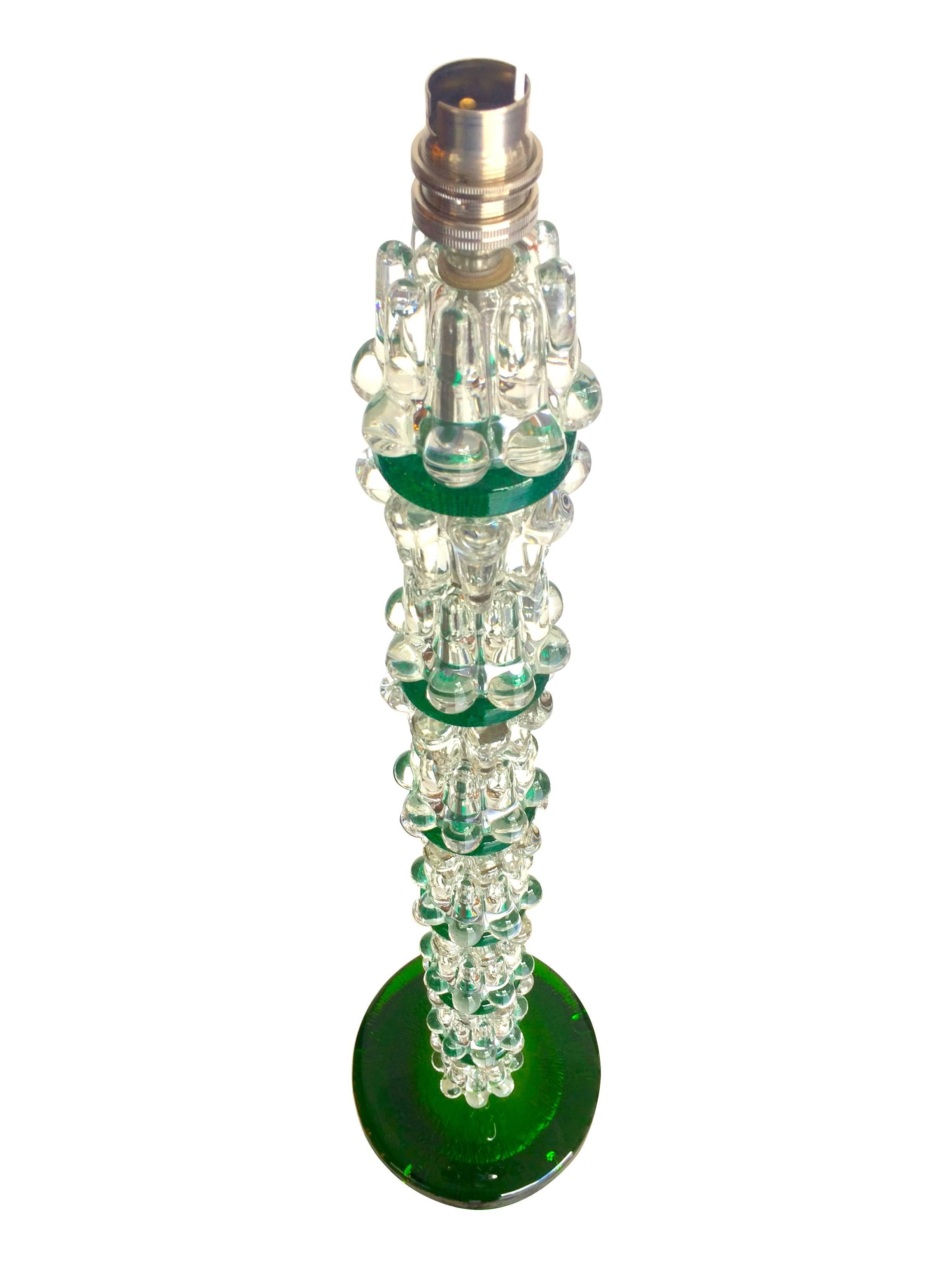 A large pair of green Orrefors glass lamps with clear and green glass stem on a green glass base with single nickel fitting on each, rewired with antique silver cord flex and PAT tested.