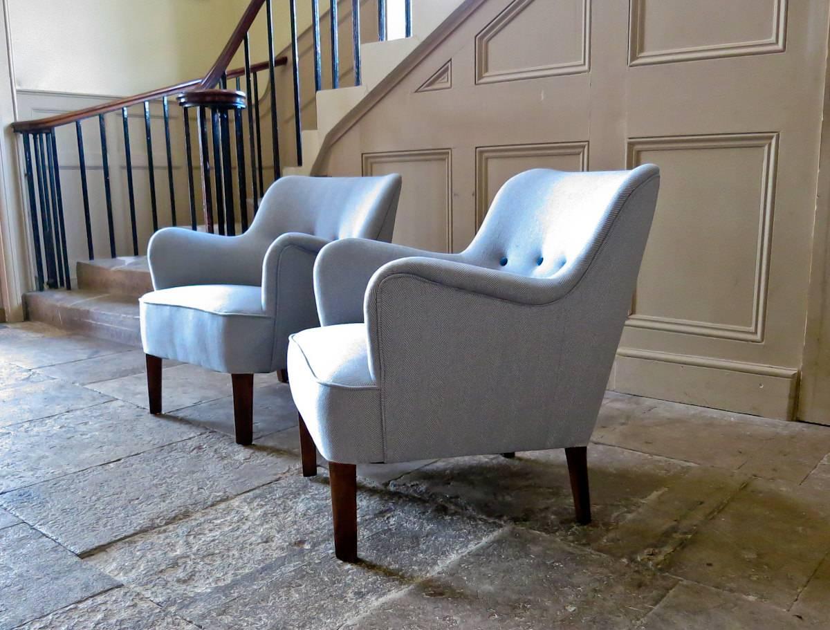 An original pair of Fritz Hansen Danish armchairs designed by Orla Mølgaard Nielsen in 1951, newly reupholstered in a light blue wool fabric with matching velvet buttons.

A beautiful pair of armchairs of organic form so very typical of 1950s