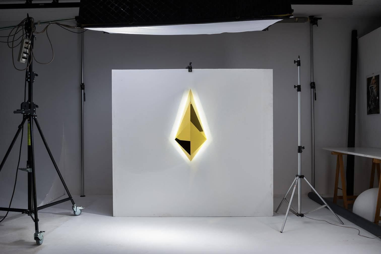 Wall light large, made of brass or aluminum gold finish with LED lighting. Through the study and application of sacred geometry, Gio Minelli creates with her bright work, conditions to induce the mind to silence and contemplation.

Biography
Gio