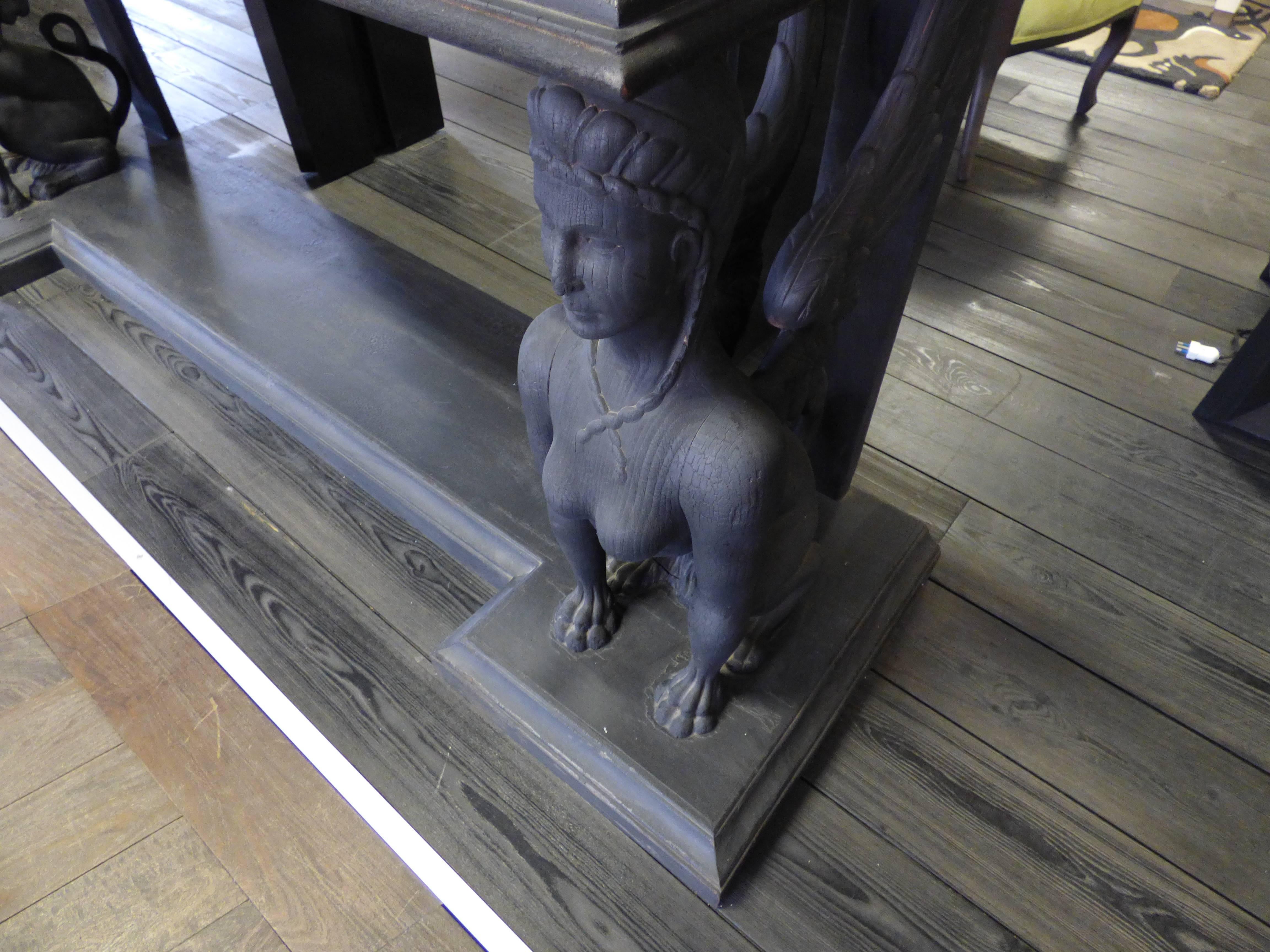 Console table with hand-carved sphinxes. Finish burned black wood. Designed by Ferruccio Laviani and produced by Fratelli Boffi.