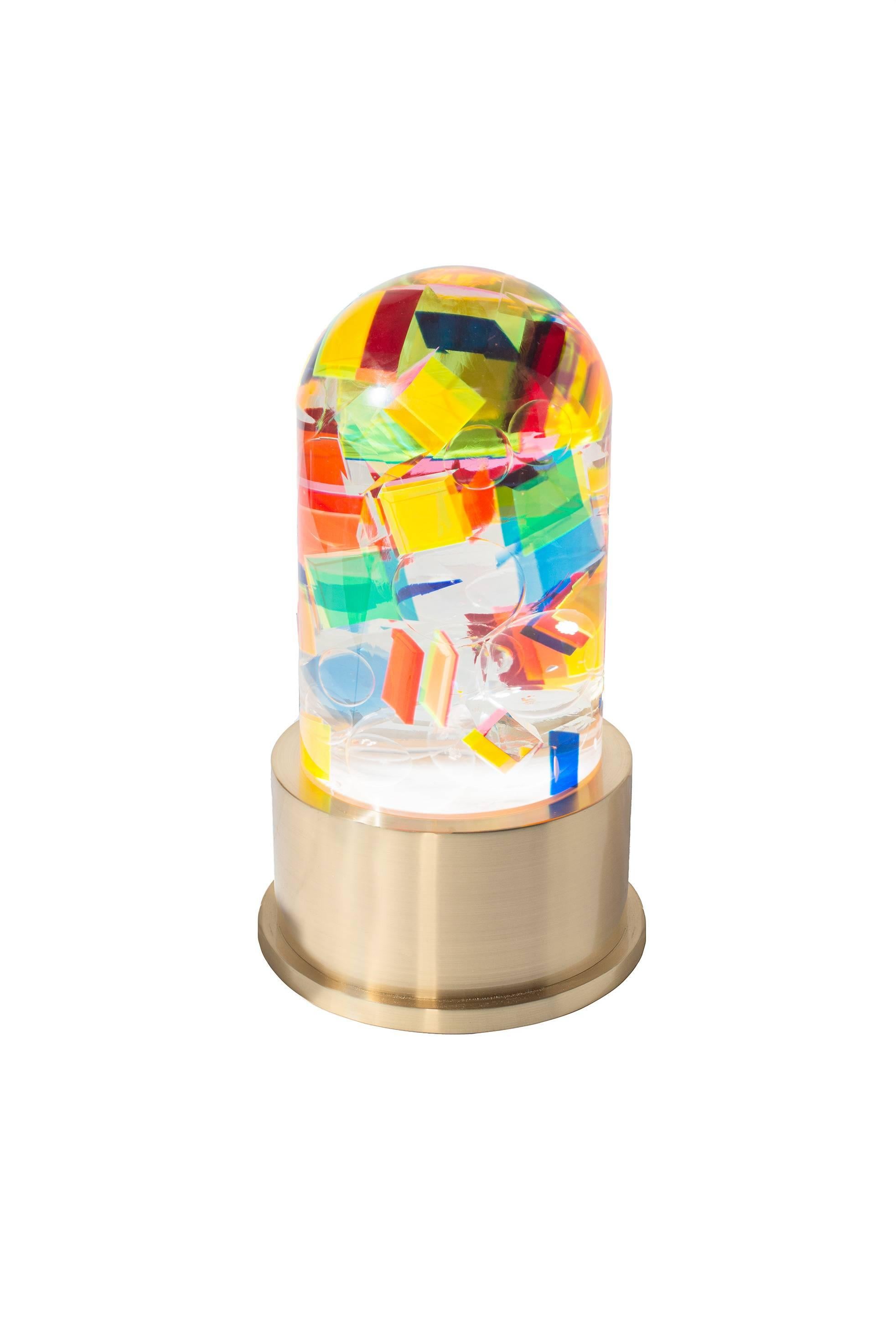 A beautiful and colorful plexiglass table lamp with brass base designed by Studio Superego for Superego Editions, in 2016. The lamp is called Caos for the effect obtained from the pieces of plexiglass incorporated inside along with transparent
