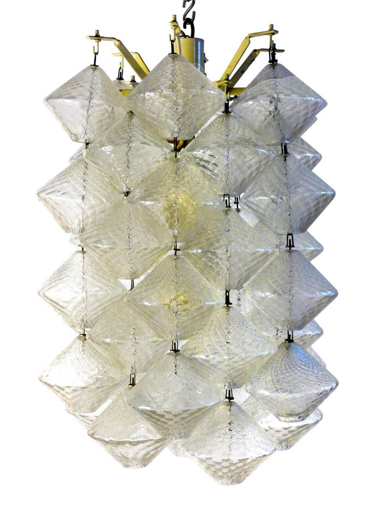 Pair of Murano glass chandeliers with metal structure, blown glass elements, produced by Salviati in 1956 and designed by Vinicio Vianello.
 