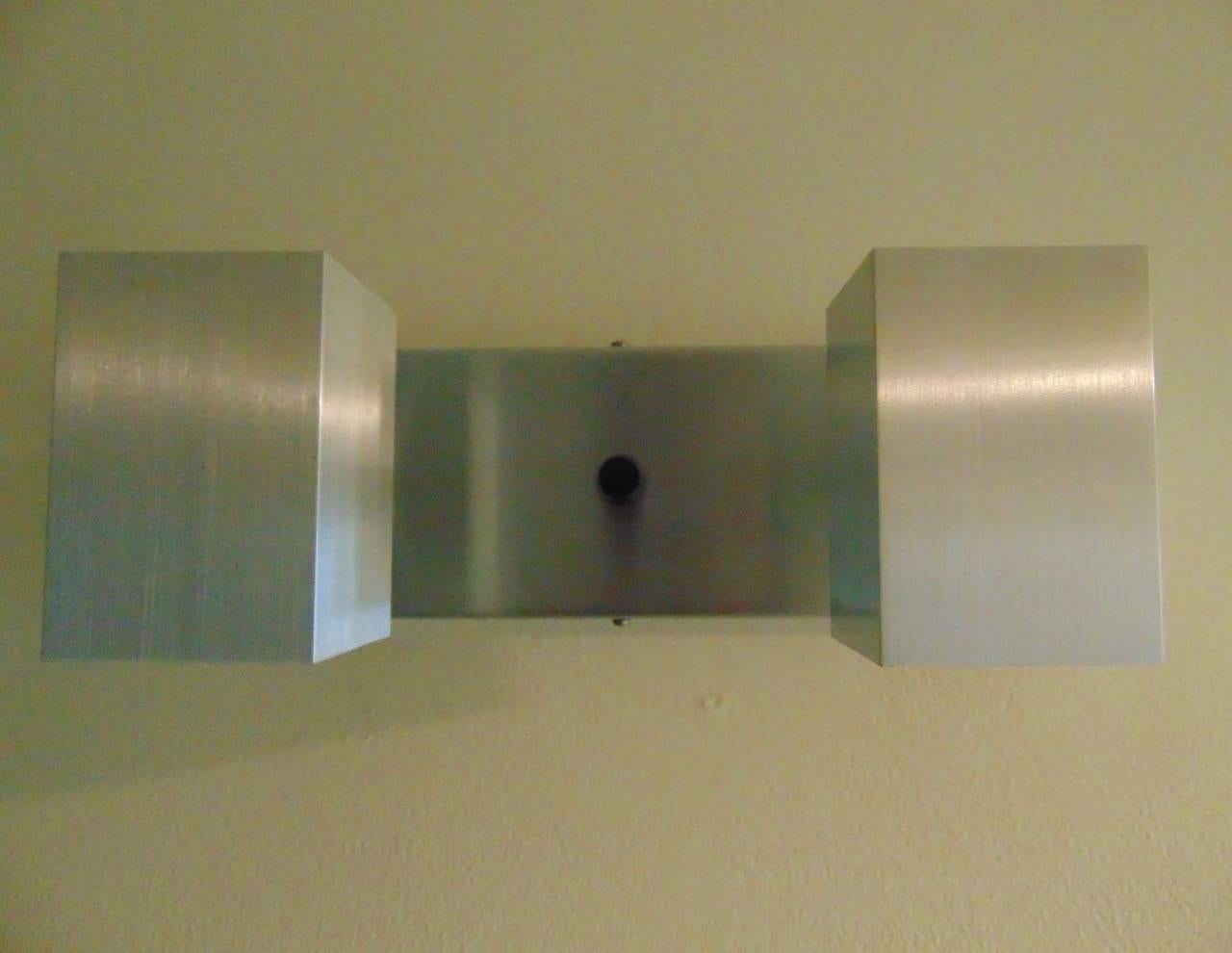 A vintage Mid-Century wall light designed by David Hurst in the 1960s-1970s and manufactured in England.
The light is wall-mounted with a double bulb feature which projects light downwards with a central switch.
This light is silver, we are also