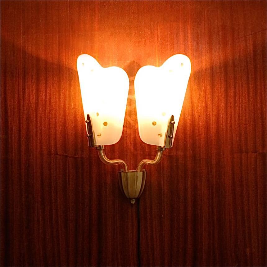 An original and magnificent example of craftsmanship, this pair of wall sconces are made from almost entirely from glass, except for the brass wall mounts and screws. Polka dot motif etched in the glass. There are in good vintage condition and in
