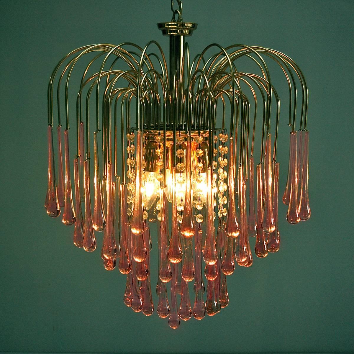 Mid-20th Century Murano pink crystal teardrop chandelier by 1960s Italian designer Paolo Venini. There are seventy-seven pink teardrops suspended from delicate brass extensions that seem to jet from the central light fitting like a water fountain.