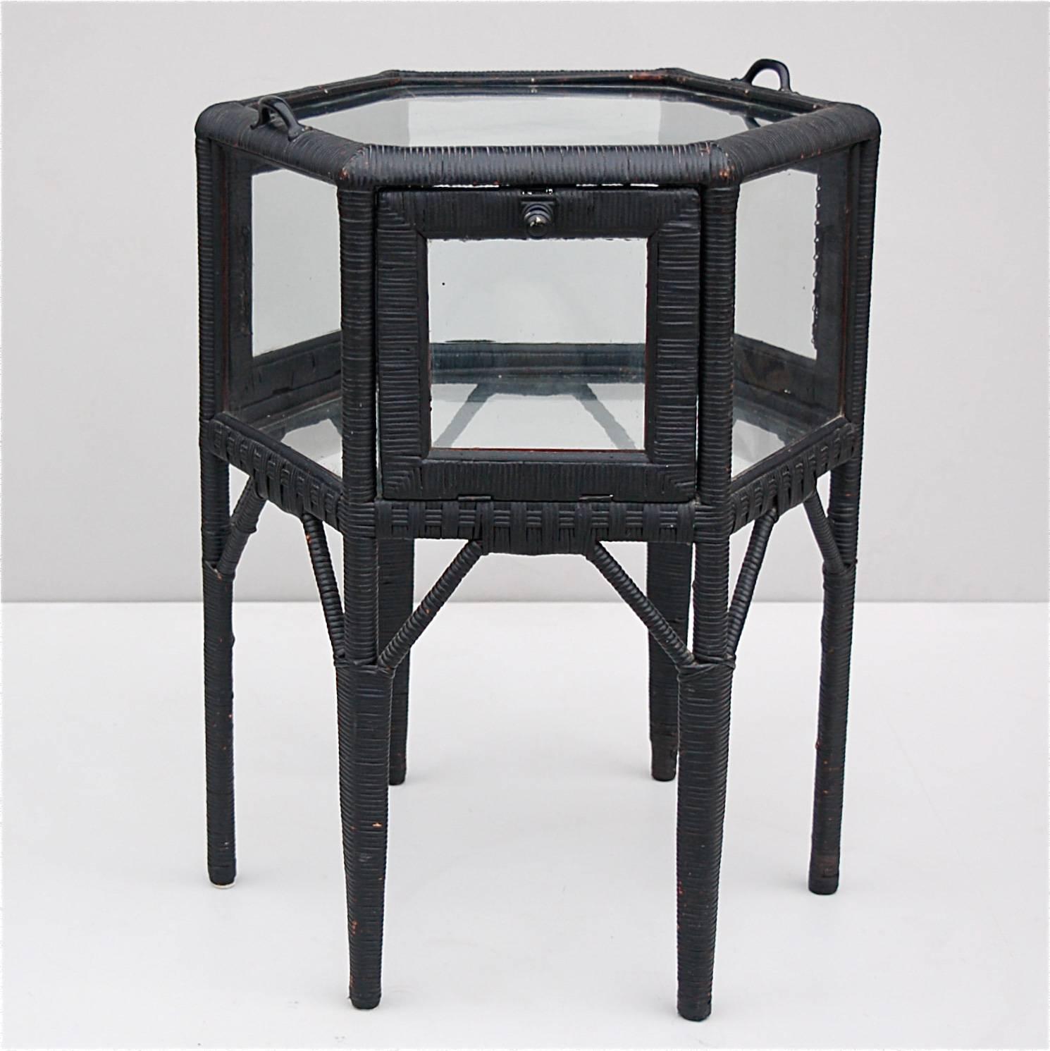 Highly unusual side table that also doubles as a vitrine, console or display table. The top part is a display case with six glass side panels of which three open to give access to the main body of the unit. The glass is very thick and handmade. The