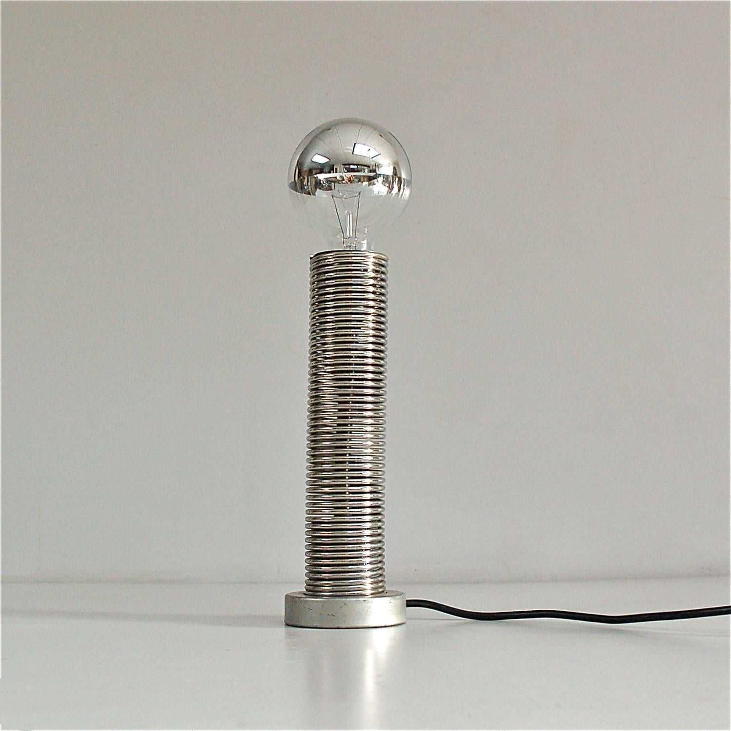 Coil or spring lamp with a flexible, bendable arm that can be adjusted to direct the light. Suitable for use as a table or desk lamp.