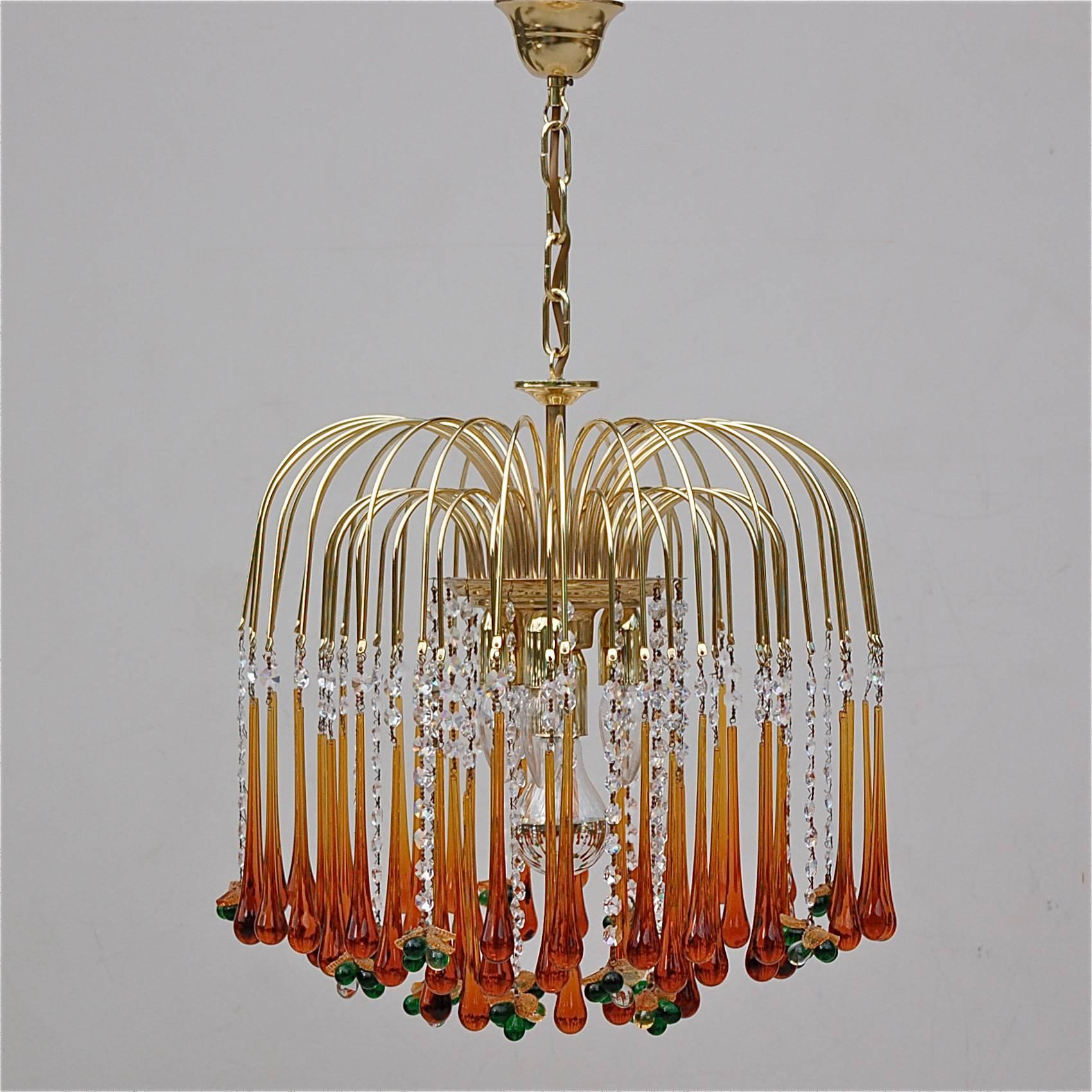Late 20th century deep amber coloured Venini glass teardrop chandelier. There are 51 teardrops suspended from a double ring of delicate extensions that seem to jet from the central light fitting like a water fountain. The teardrops are punctuated at