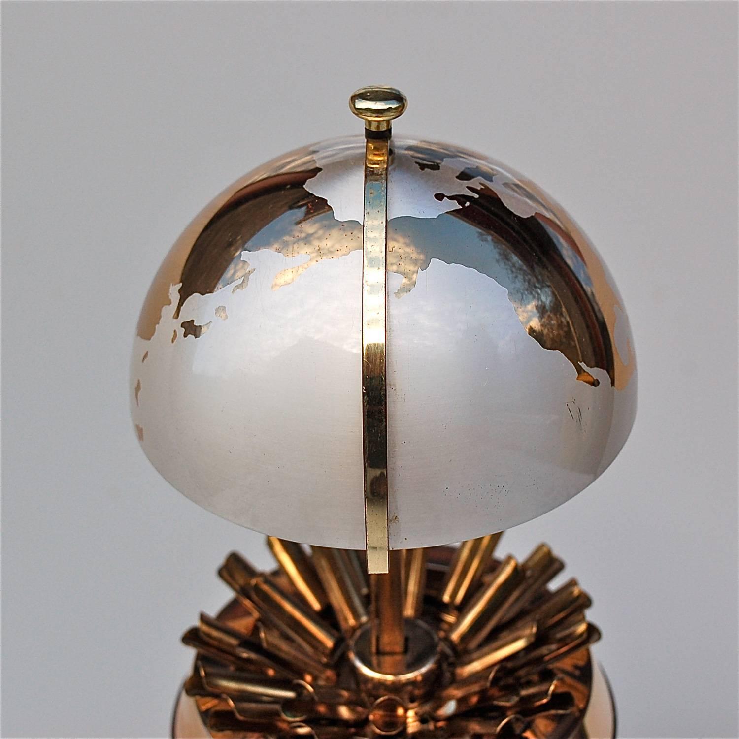 At first sight, you'd never imagine this weighty, shiny globe would morph into a cigarette dispenser. By a simple pull at the top axis, the top hemisphere slides open revealing the inner compartment with room for 25 cigarettes. This lovely