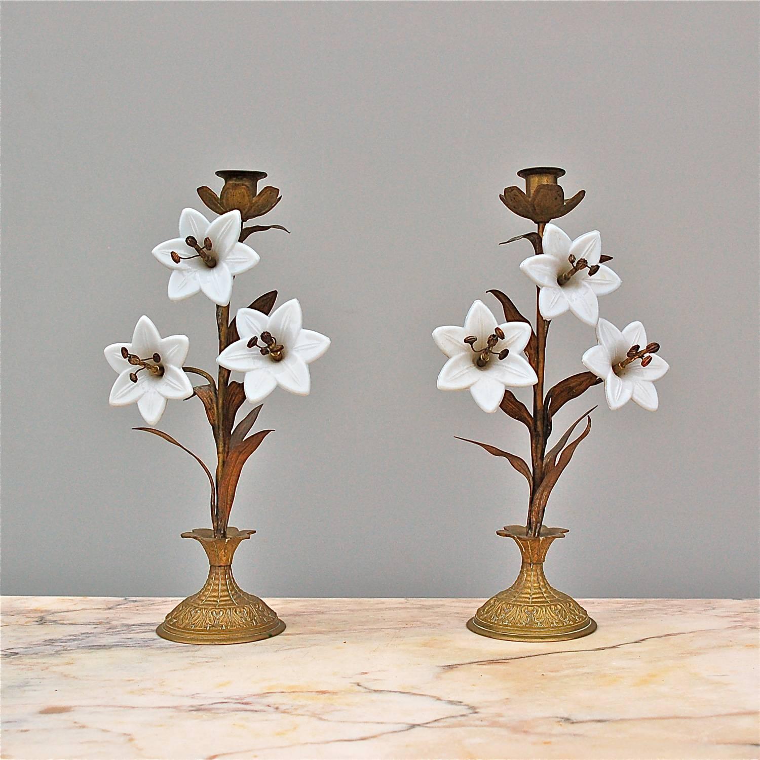 A matching pair of 19th century French, candlesticks which originally would have been used on a church altar. Each candlestick is made from finely embossed brass decorated with Fine, long leaves and white opaline glass flowers that represent the