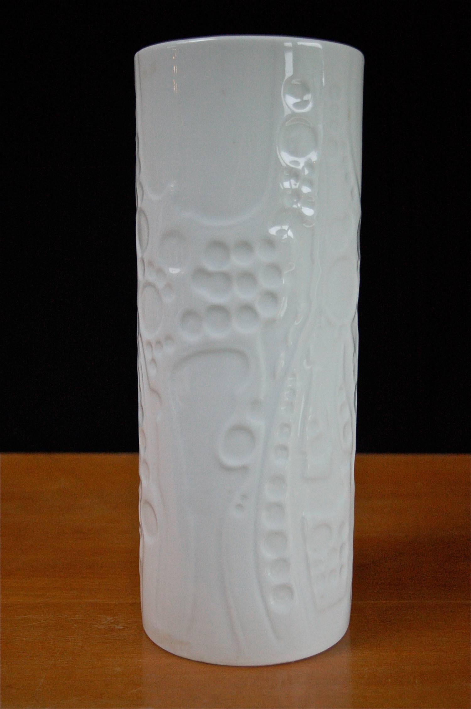 The outer surface of this large tubular vase consists of a raised pattern of wavy lines with indented circles of varying sizes. It has a glazed finish, making it a very tactile piece. The vase is marked with pattern number 7840/2.  This piece was