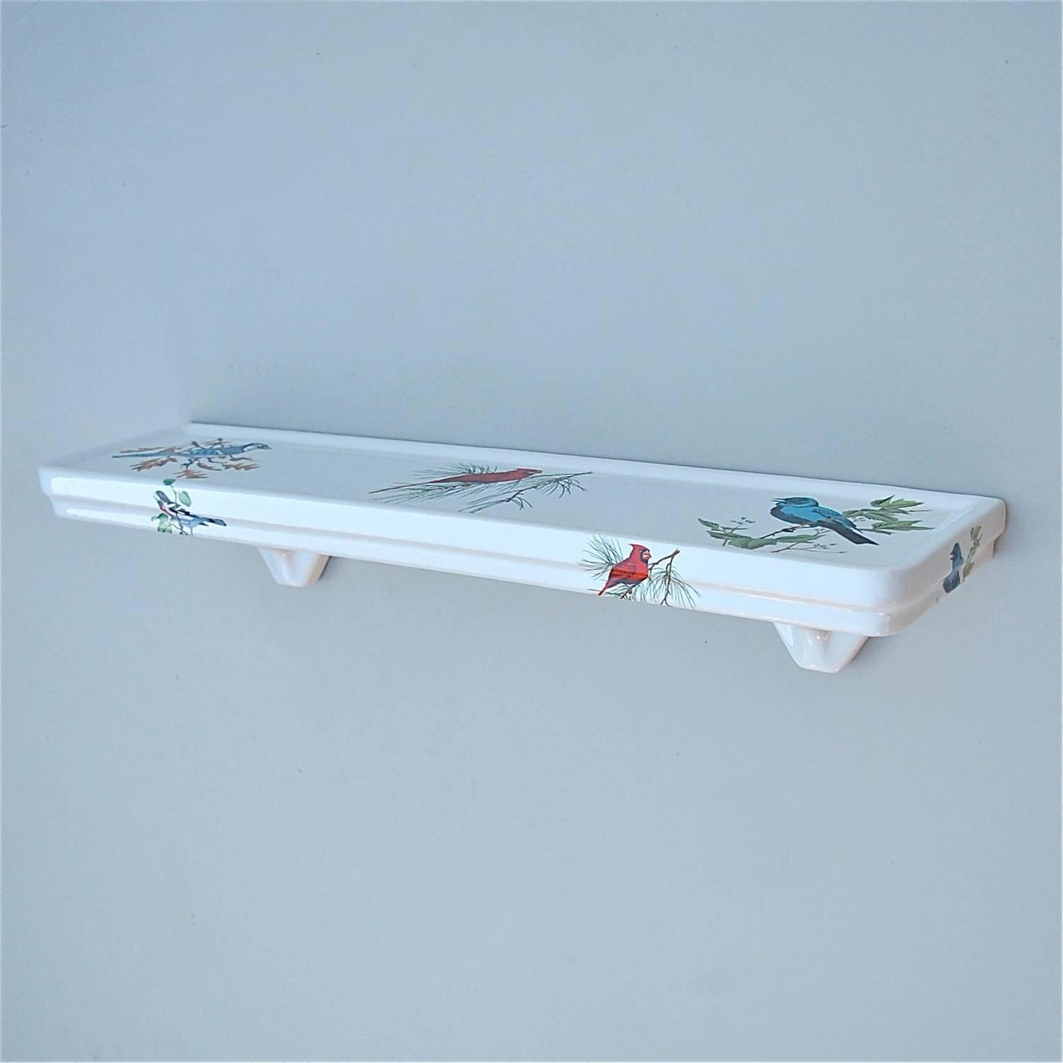 Vintage, retro bathroom shelf or vanity shelf made from solid French porcelain. Usually these period wall-mounted bathroom salvage elements are made from plain white porcelain. The transfer printed decoration of three different types of bird makes