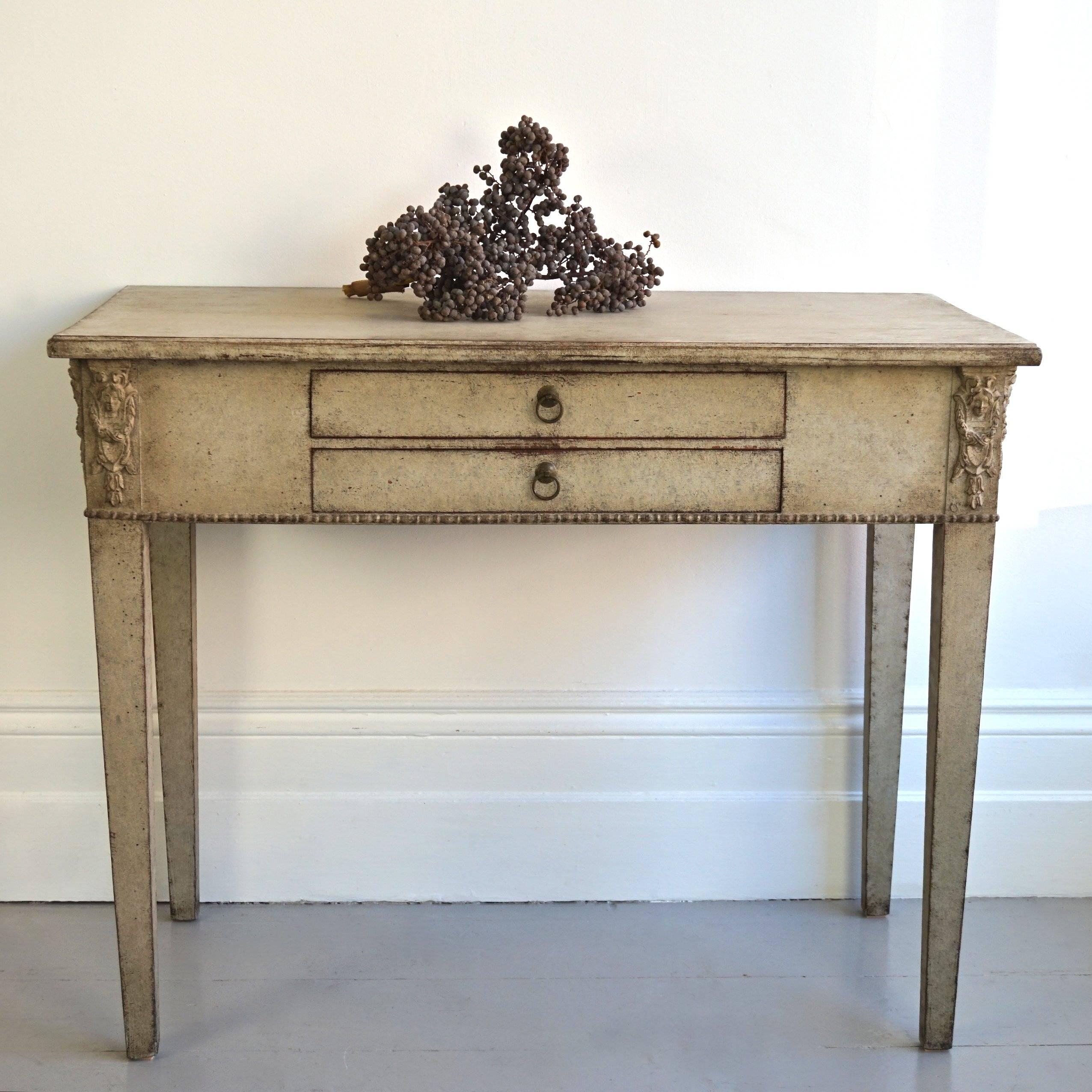 A very fine late Gustavian period side table or console with a rare two drawer configuration and decorative Empire carvings to each corner. A beautiful piece that would work wonderfully as a small writing desk, or dressing table, Swedish, circa
