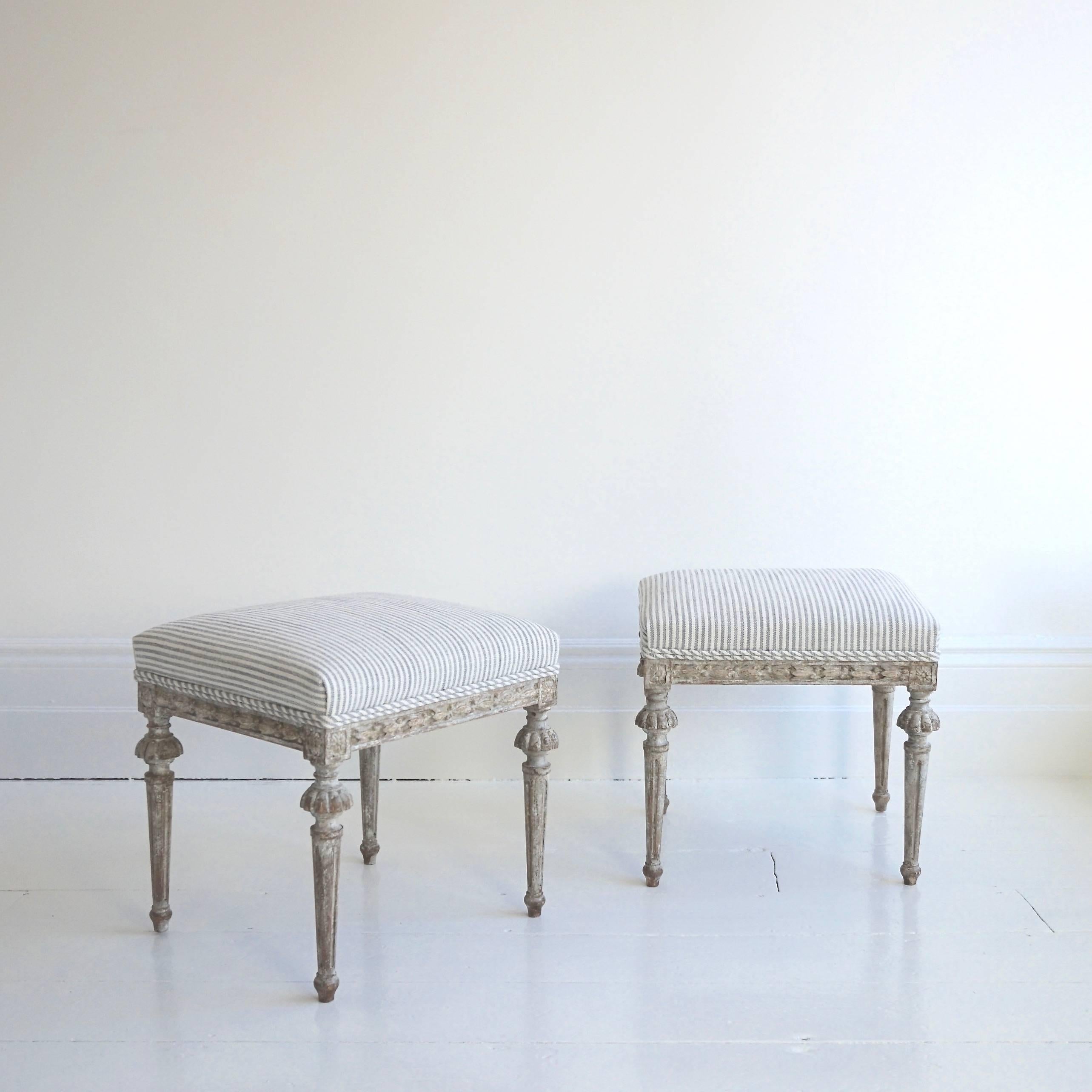 An exquisite and very fine pair of hand-carved early 19th century Gustavian period stools in their stunning original color, recently upholstered in beautiful Designers Guild grey ticking, Swedish, circa 1810.

Continental US Shipping:
We ship to