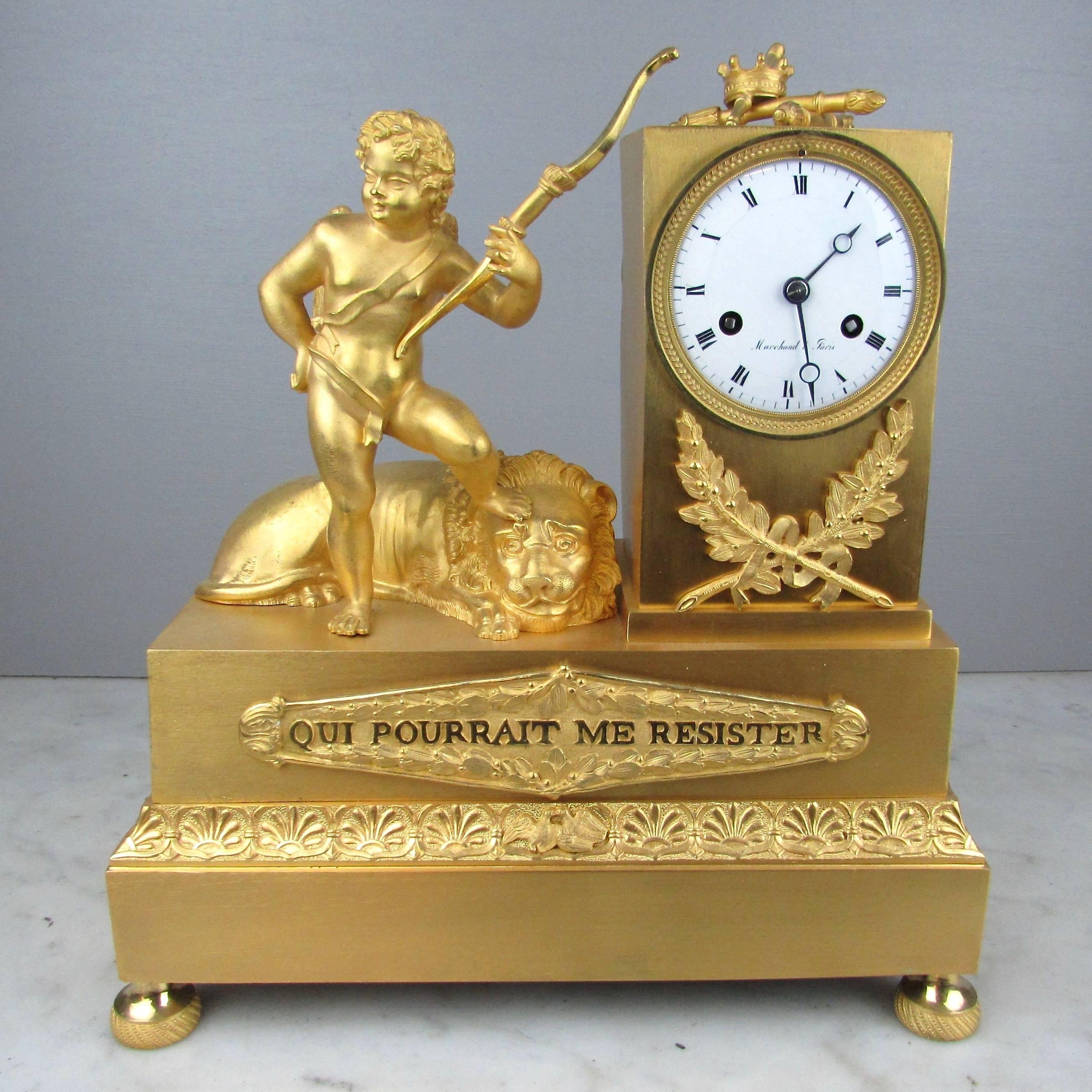 A very fine early 19th century gilded French classical design mantel clock, newly serviced in excellent working order. The case features a beautiful winged cherub holding a bow, standing next to a lion. The front of the case features a gilt plaque