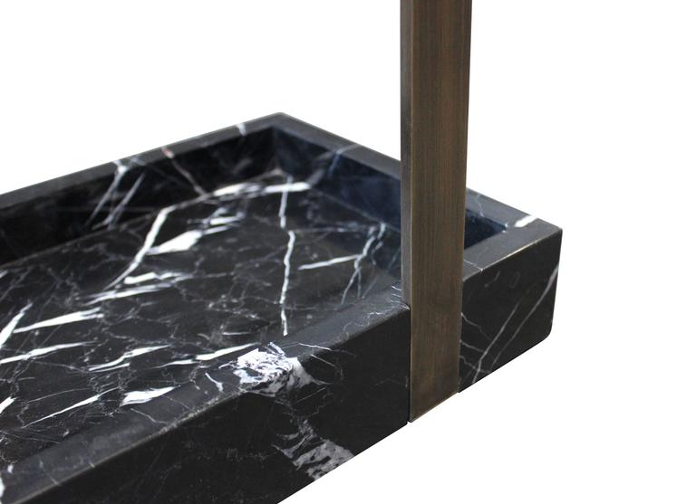 This subtle yet striking umbrella stand creates an arresting focal point to a foyer or vestibule. Shown here in patinated bronze with nero marquina marble, the piece is handmade to order in New York City and can be specified in any number of custom