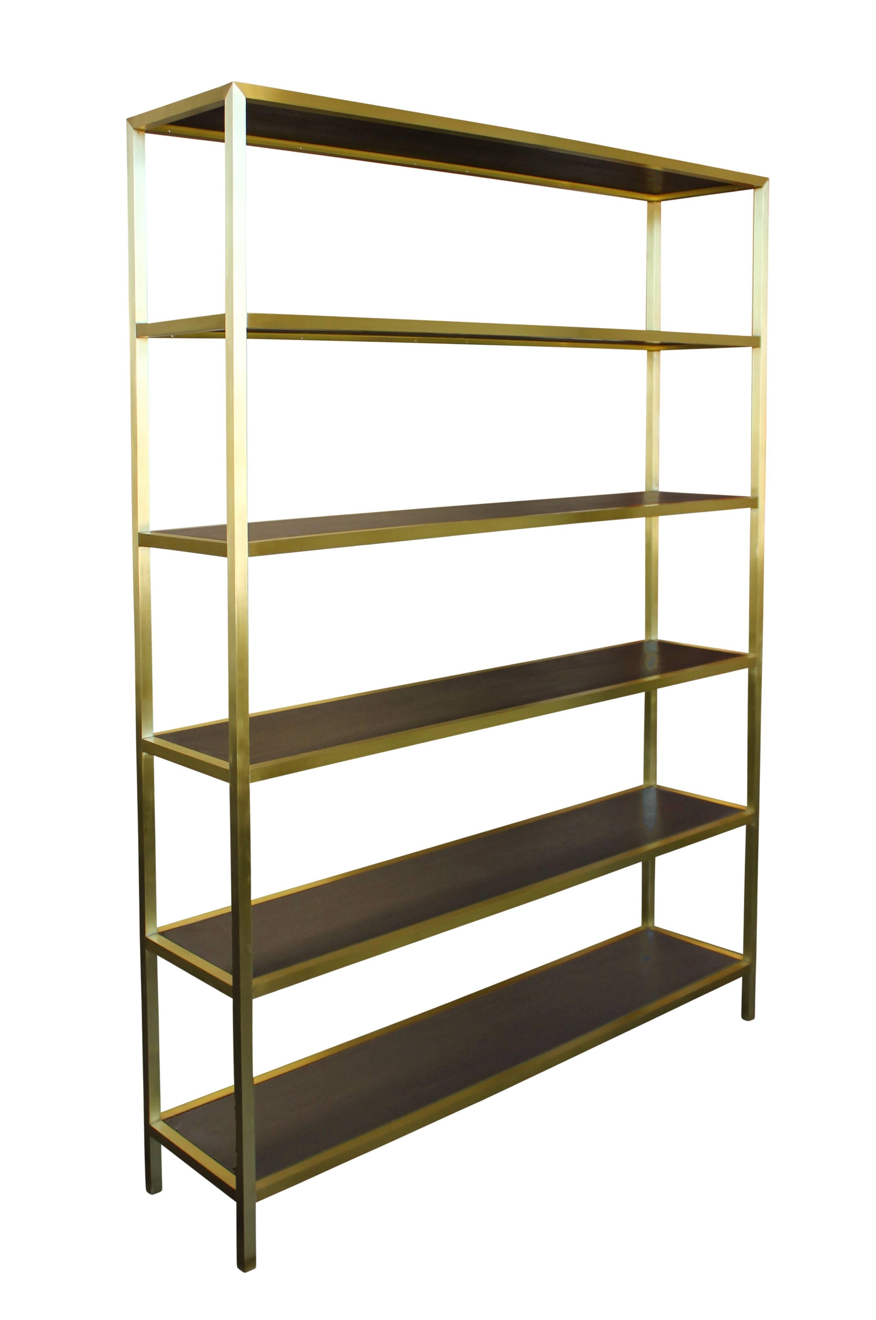 Brass frame etagere in satin finish with inset stained walnut shelves. With its dramatic proportions and luxe material palette this is a piece that defines a room. Available in custom sizes, finishes, and materials.