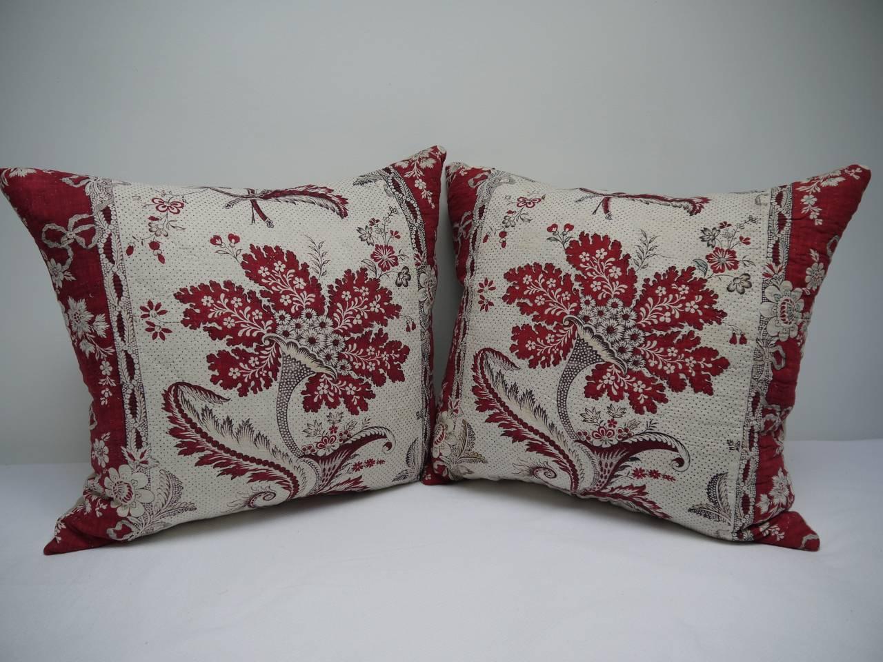 Pair of cushions made from a French, circa 1790s block printed cotton and linen called 'La Cornue Fleurie'. A toile manufactured by Petitpierre Freres, Nantes. In excellent condition with a very striking design. Backed in a vintage