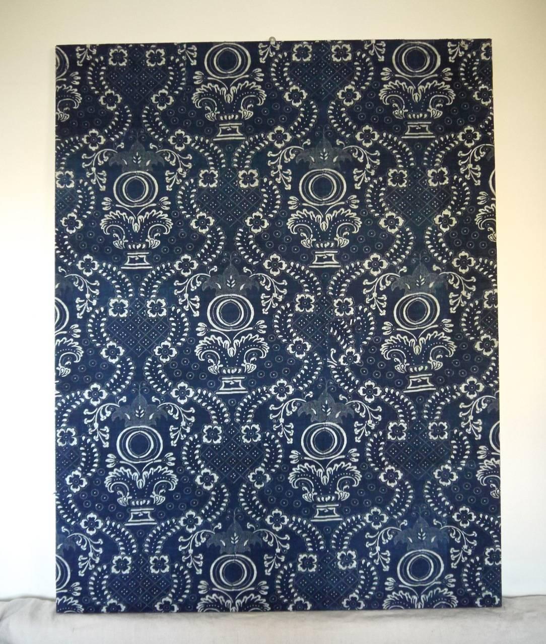 A French indigo resist block printed on cotton, circa 1800. Now mounted on a pine stretcher. To make a great wall decoration. Striking design of pomegranate motifs.