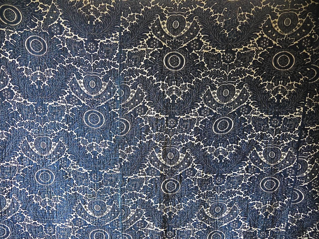 18th century, French indigo resist quilt, block printed on a siamoise (cotton and linen) cloth. Stylized design with arching acanthus leaves. Backed in a late 18th century block printed design of flowered baskets.
A wonderful rare piece.