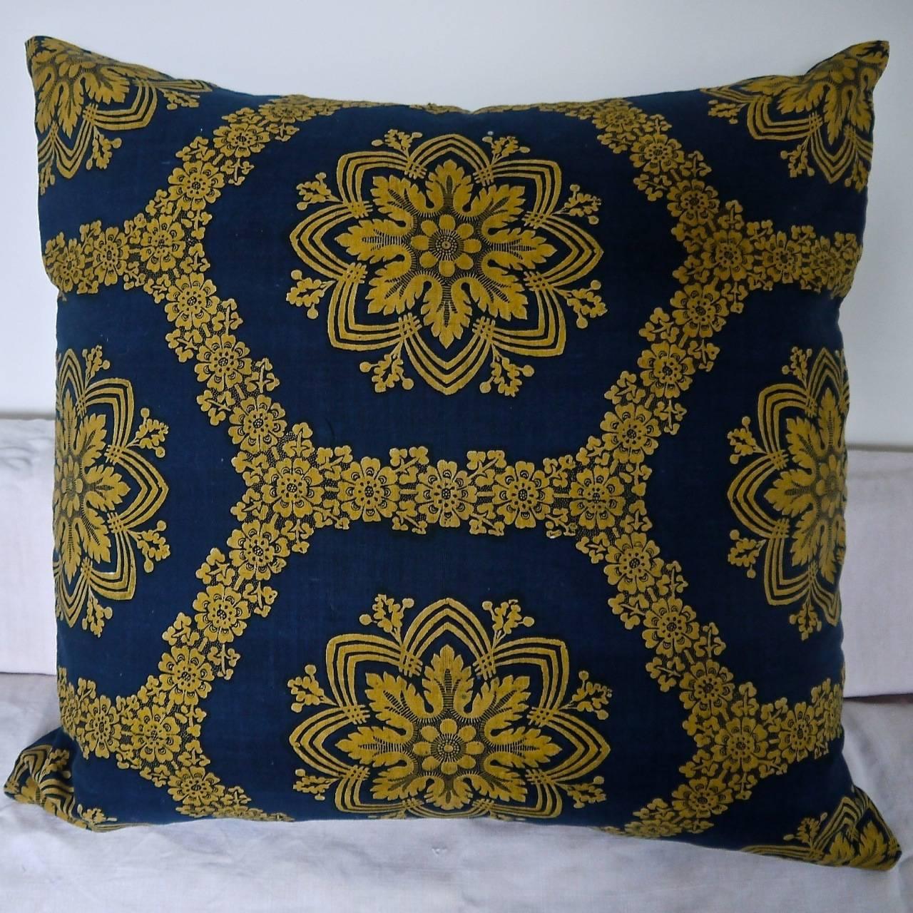 Early 19th century French Empire block printed in a strong saffron yellow and indigo resist cotton cushion. Unusual large-scale design
Backed in a natural indigo hand dyed 19th century French linen and slipstitched closed with a duck feather