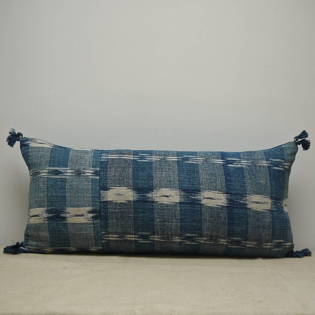 French indigo flamme linen and cotton mix cushion, circa 1800. Original seamed piece with two different flamme patterns. Antique French cotton tassels on each corner and backed in a hand dyed natural 19th century French linen. Slip-titched closed