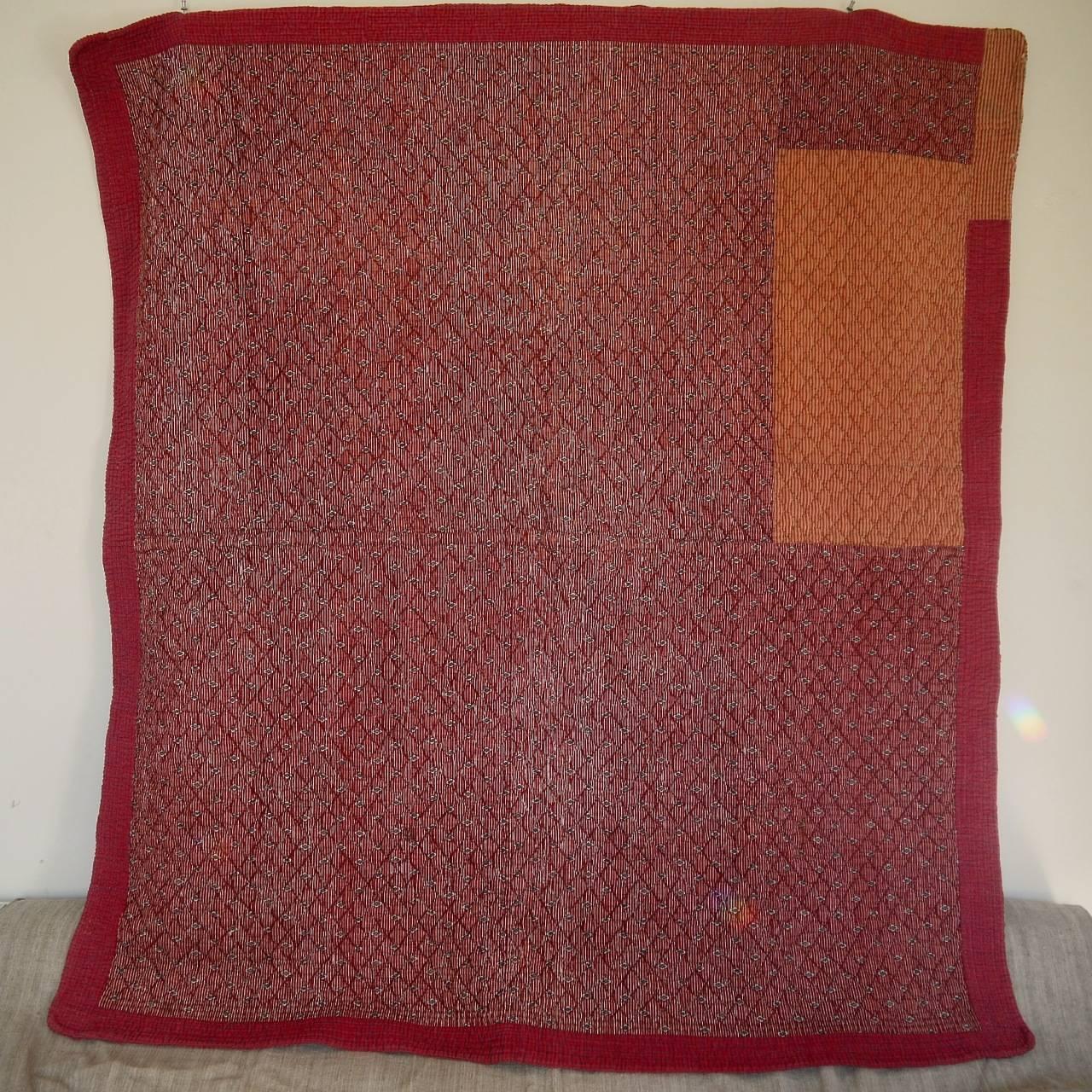 Late 18th century, early 19th century French quilt in a small-scale cotton print. The border and reverse of the quilt is in a small red and indigo check.
Charming rustic piece with small bits of damage here and there including the top right hand