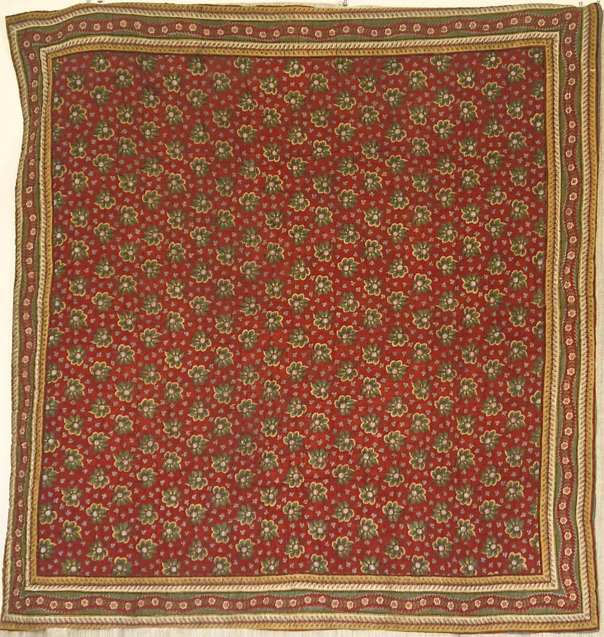 Early 19th century French mouchoir de cou, a woman's neckerchief, that has made into a charming small quilt. Simple block printed green leaves on a beautiful terracotta red ground. The reverse is an interesting wool woven on a cotton textile.
In