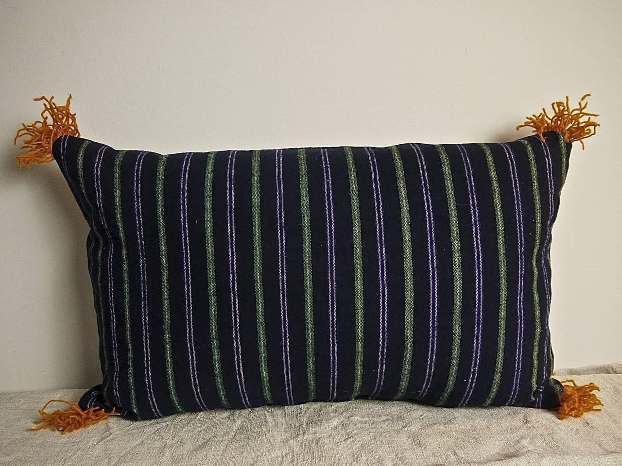 French 19th century woven cotton and wool striped cushion.Dark indigo with white, green and purple in a pleasing combination.With hand dyed orange wool fringing on each corner.Backed in a natural indigo hand-dyed 19th century French