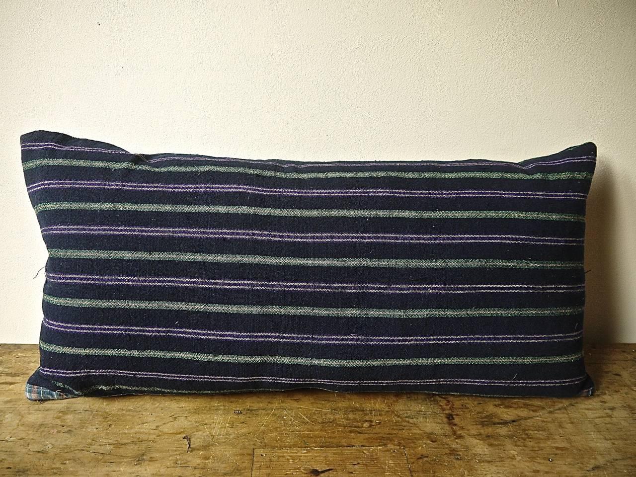French 19th century woven cotton and wool striped cushion. Dark indigo with white, green and purple colors in a pleasing combination. With an 'as found ' border of a French 19th century cotton check trim at the base of the cushion. Backed in a
