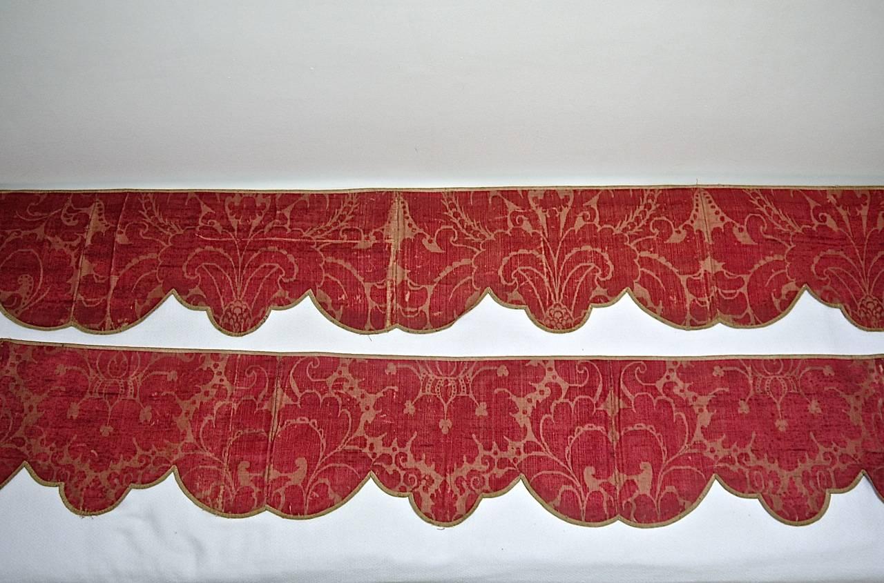 Pair of 18th century French silk damask pelmets of two different lengths. Backed in a pale rust coloured light hessian and trimmed with silk. Beautiful rich raspberry red on a paler ground.
One pelmet measures 190cm (75