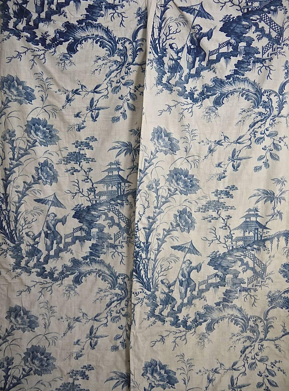 Rare and wonderful pair of 18th century French blue Chinoiserie cotton curtains, they were most likely originally bed hangings.Large-scale flowers, figures and pagodas.Printed on a soft and slightly coarsely woven cotton with its original rustic