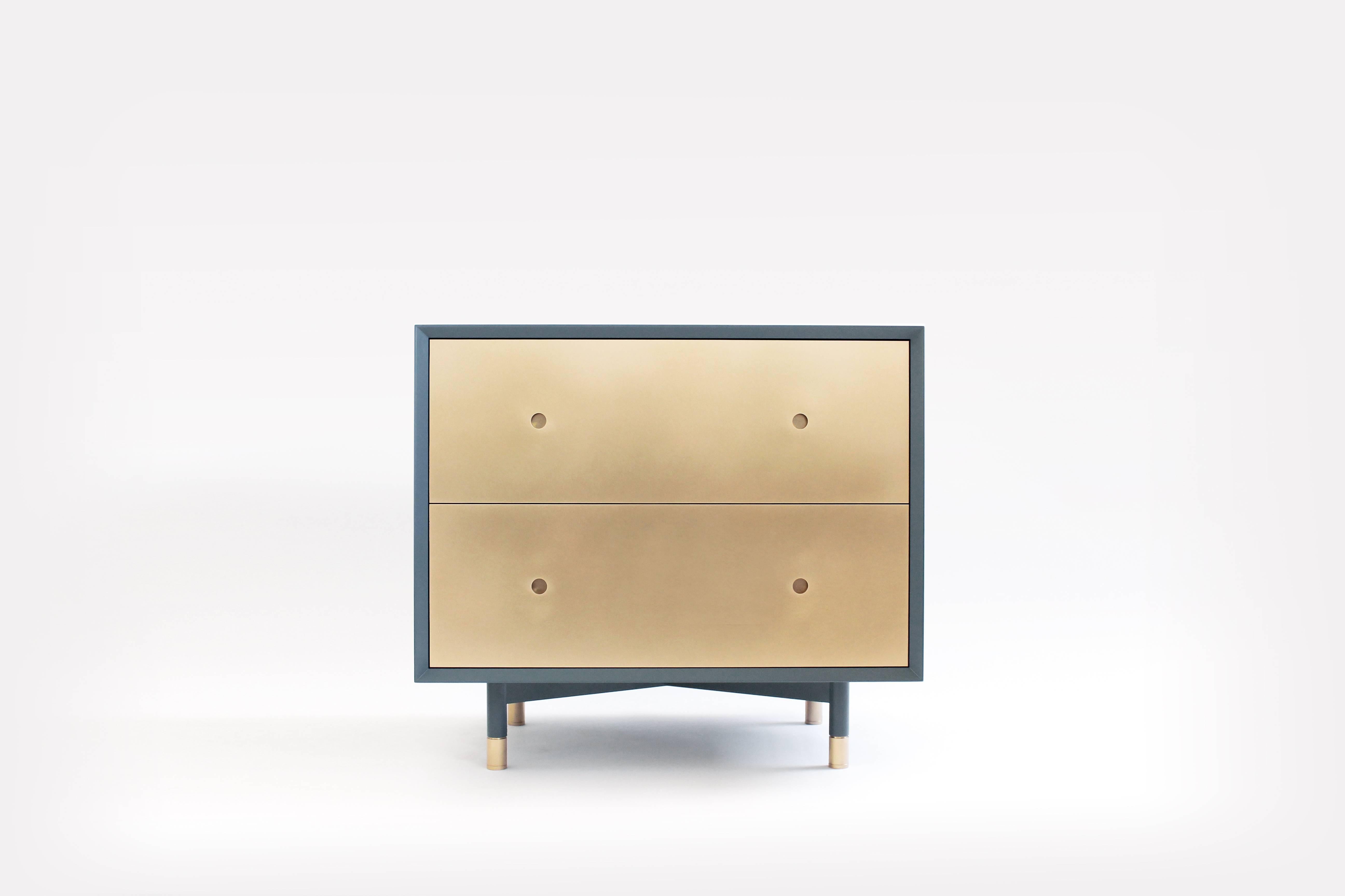 The Julie nightstand is a contemporary piece handcrafted in our Brooklyn wood shop. It is constructed of lacquered wood with brass fronts, and is available with two doors or two drawers (pricing listed is for the two-door version).