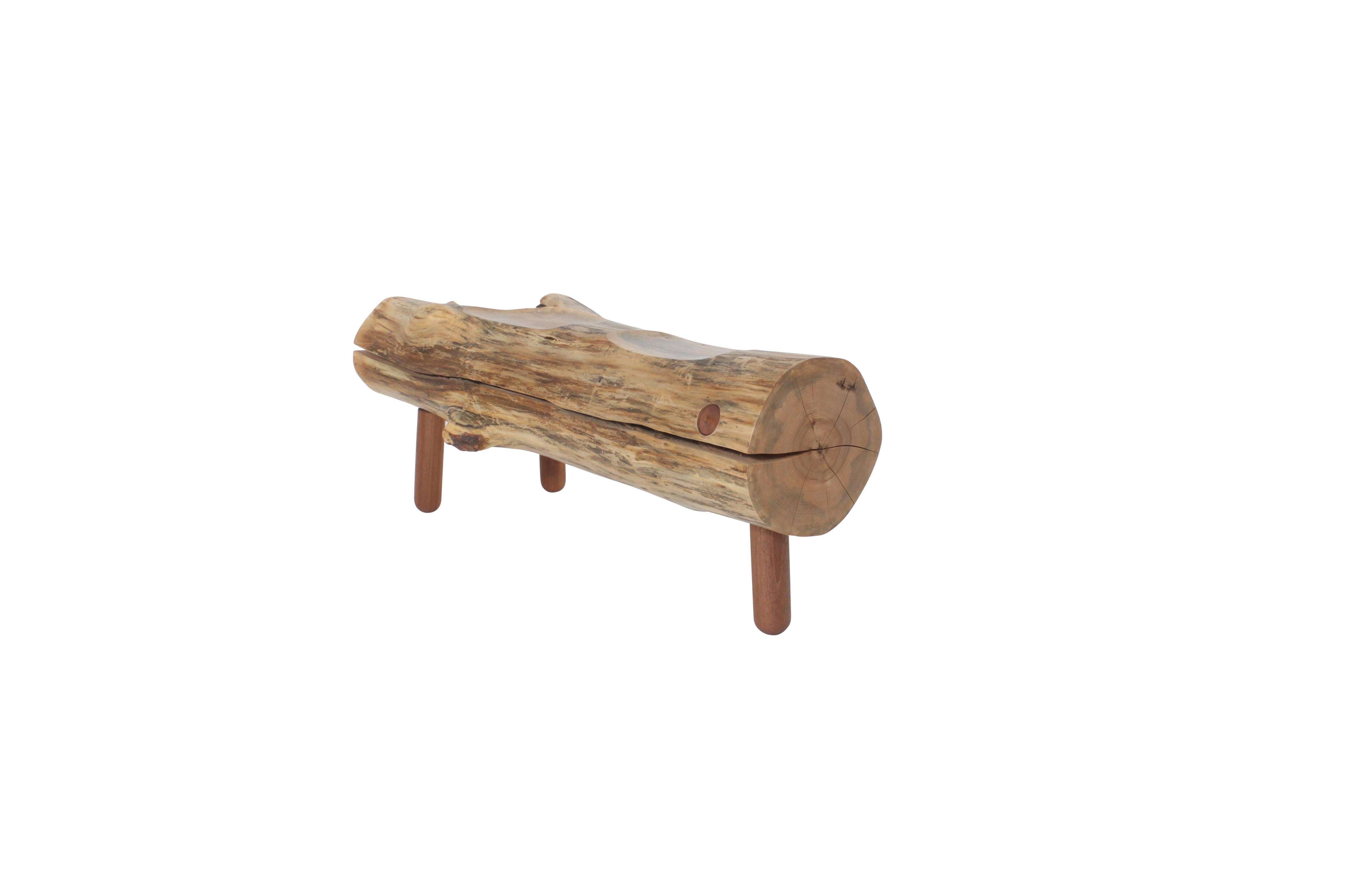 The crotch of a sugar maple that fell during Hurricane Sandy was rescued and repurposed, as a bench. This sturdy piece features two scooped out seat grooves for comfort that reveal the internal graining of the piece. The legs and a circular drawer