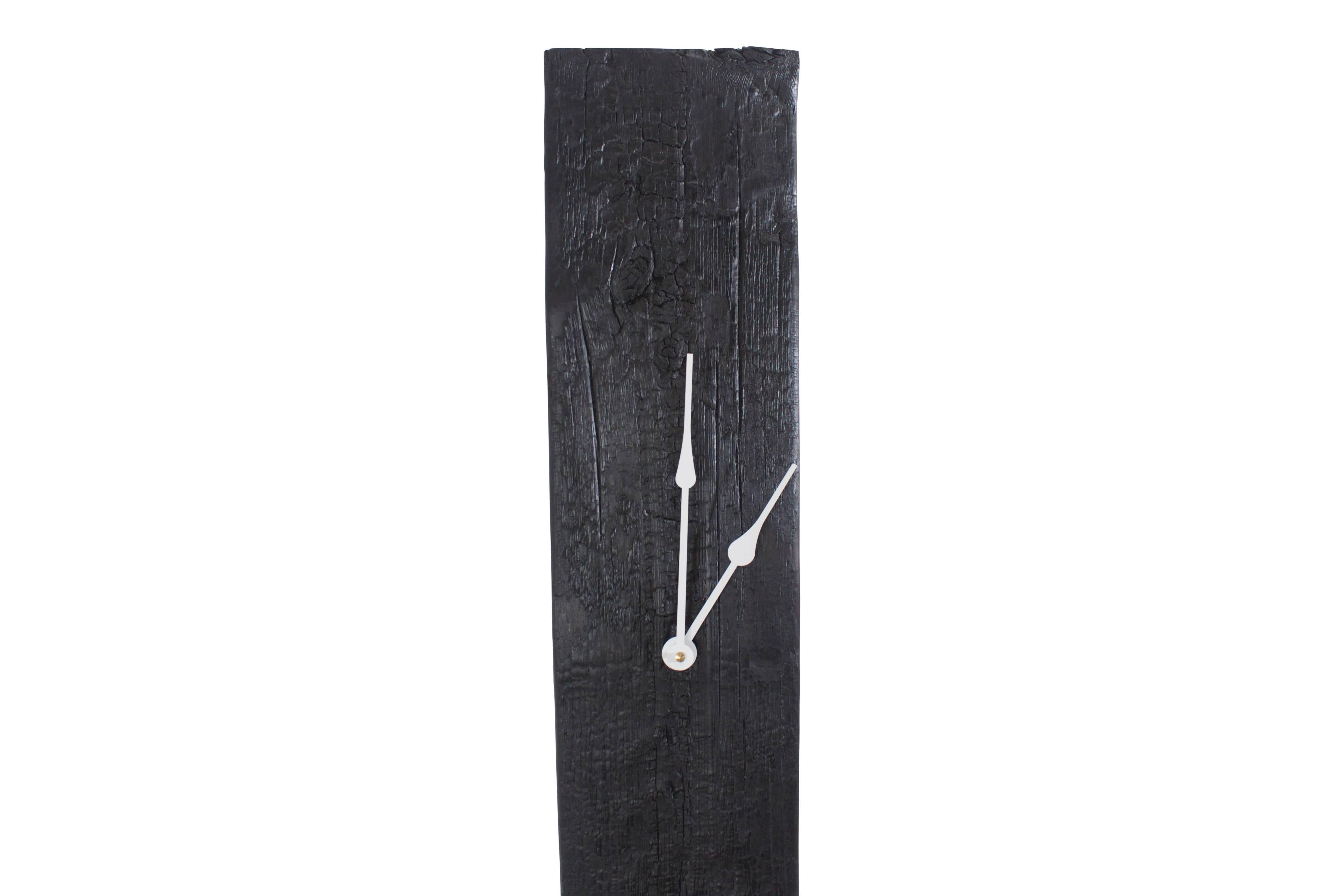 A sleek modern take on the grandfather clock. This piece is made from historic decommissioned NYC water tower wood. The wood is torched in the Shou Sugi Ban method and then sealed with oil to achieve its beautiful color and texture. The high-torque