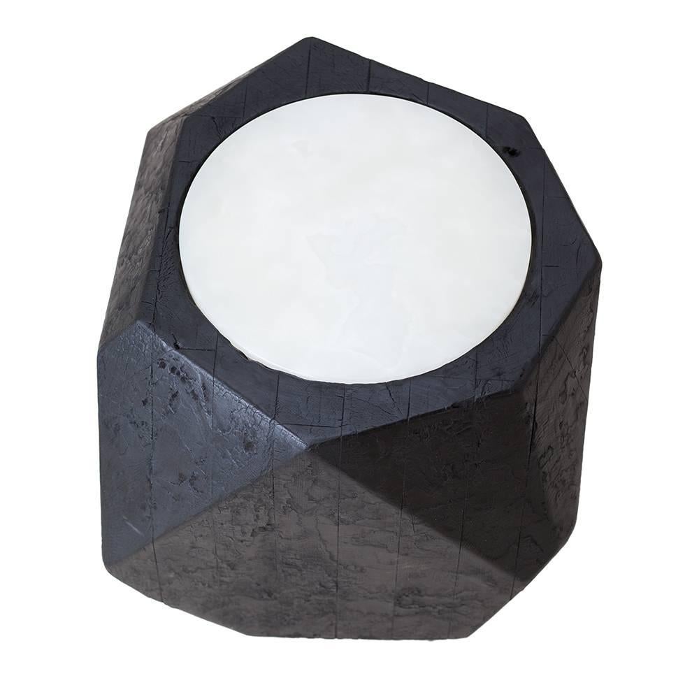 This 12-sided side table is made of layers of New York City Water Tower Cedar wood that is charred and oiled. A white onyx top is inset.

This is a bespoke piece so custom dimensions, materials, colors and finishes (both interior and exterior) can